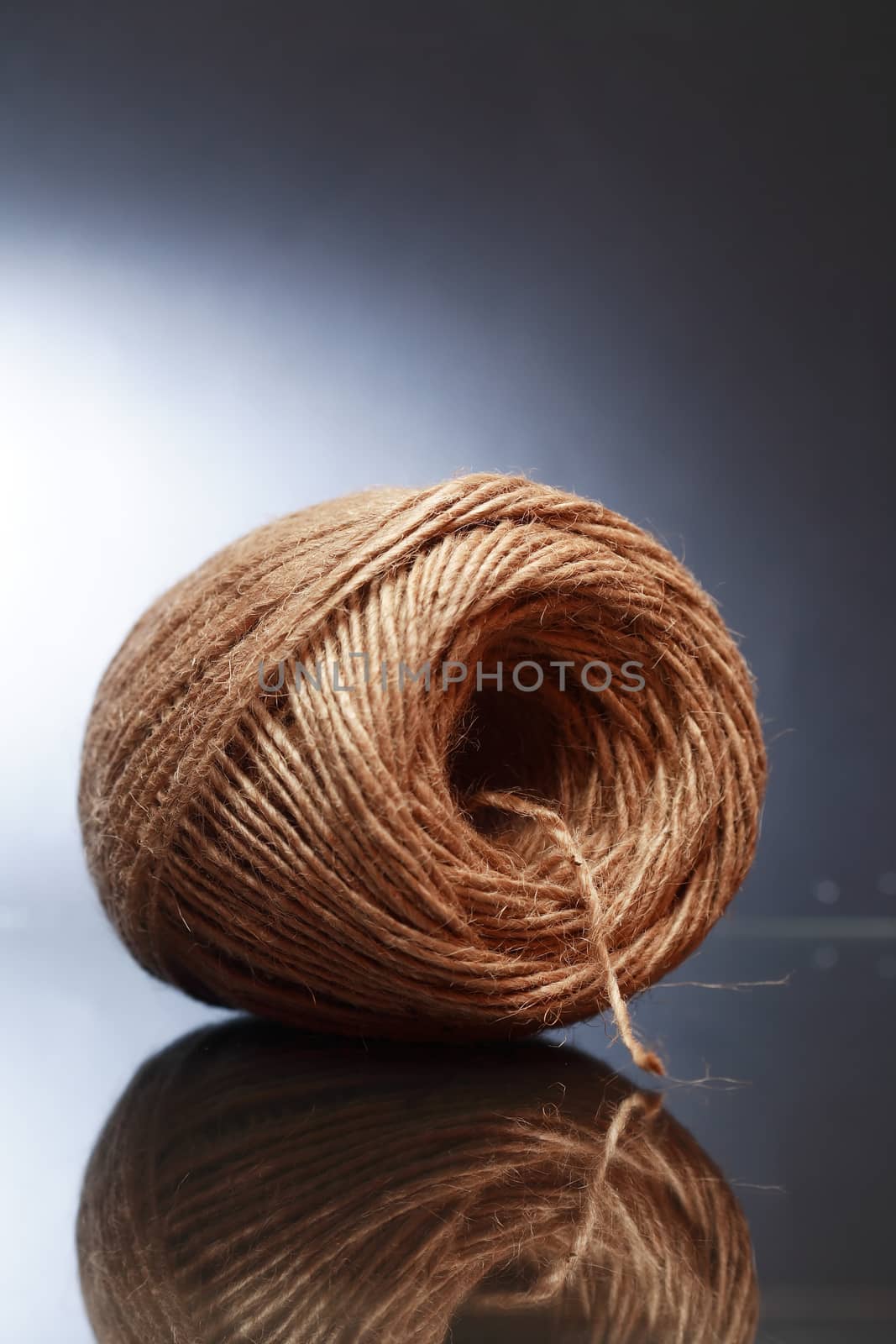 Tangle of twine on glass surface with reflection