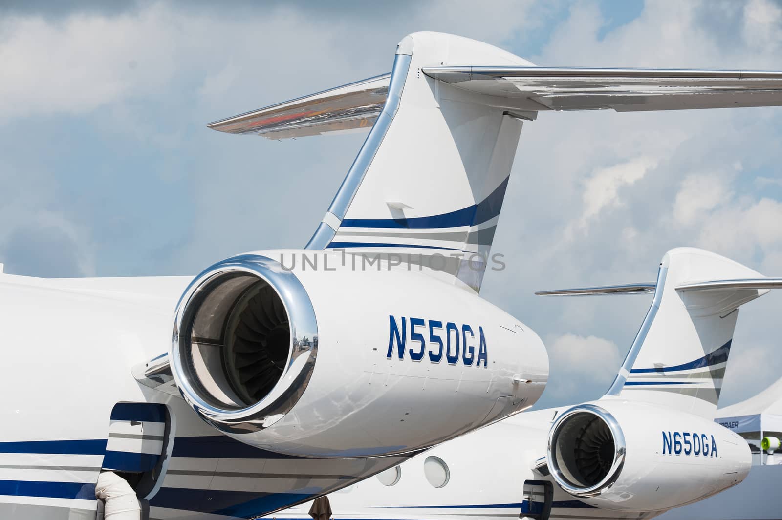 Singapore - February 14, 2016: Engines and tails of Gulfstream G550 and G650 executive jets on display during Singapore Airshow at Changi Exhibition Centre in Singapore.
