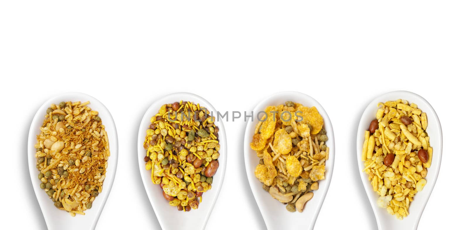 Dry roasted Indian snack mix in a big spoon, isolated