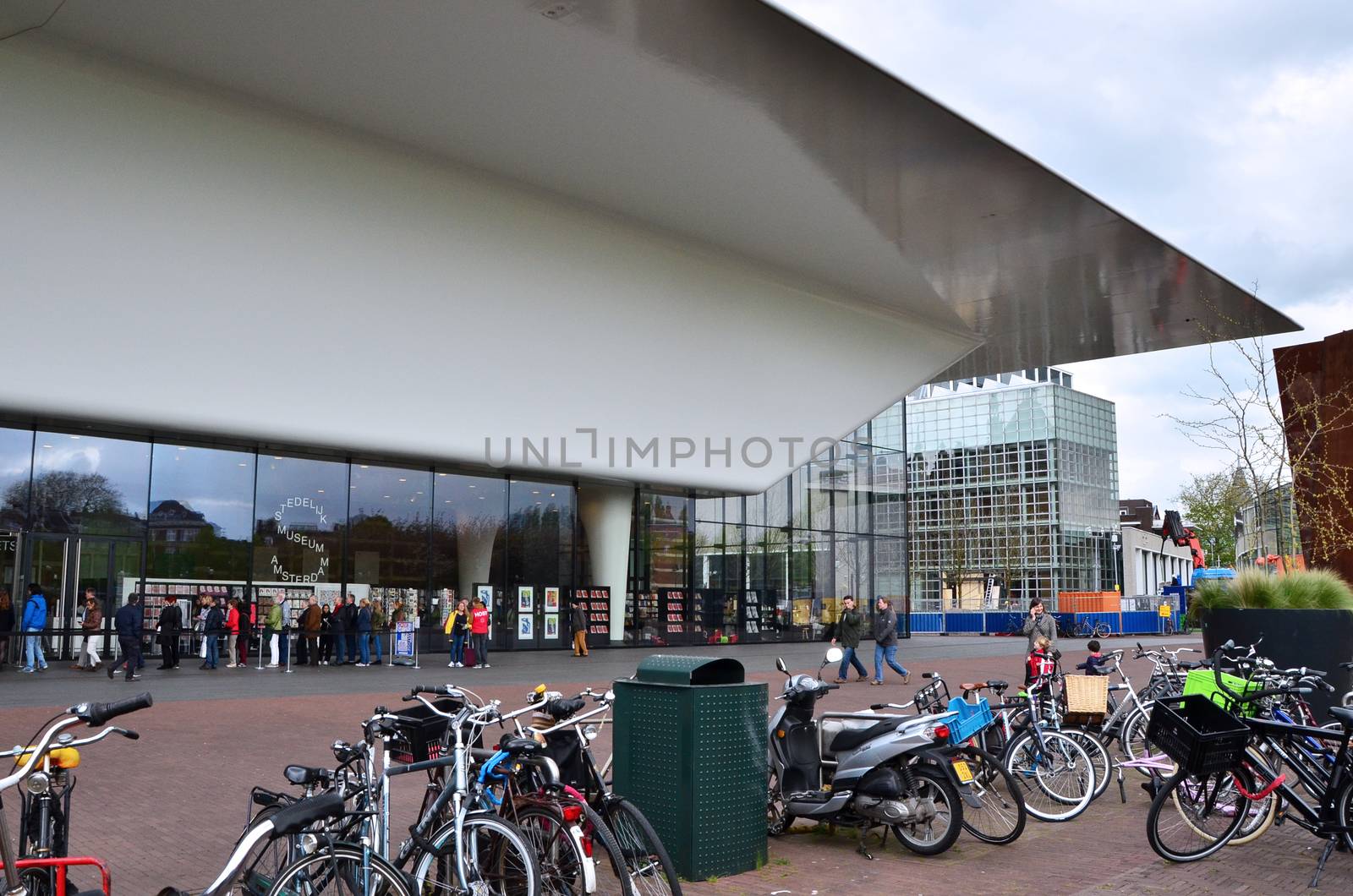 Amsterdam, Netherlands - May 6, 2015: People visit Stedelijk Museum in Amsterdam located in the museum park, Netherlands on May 6, 2015