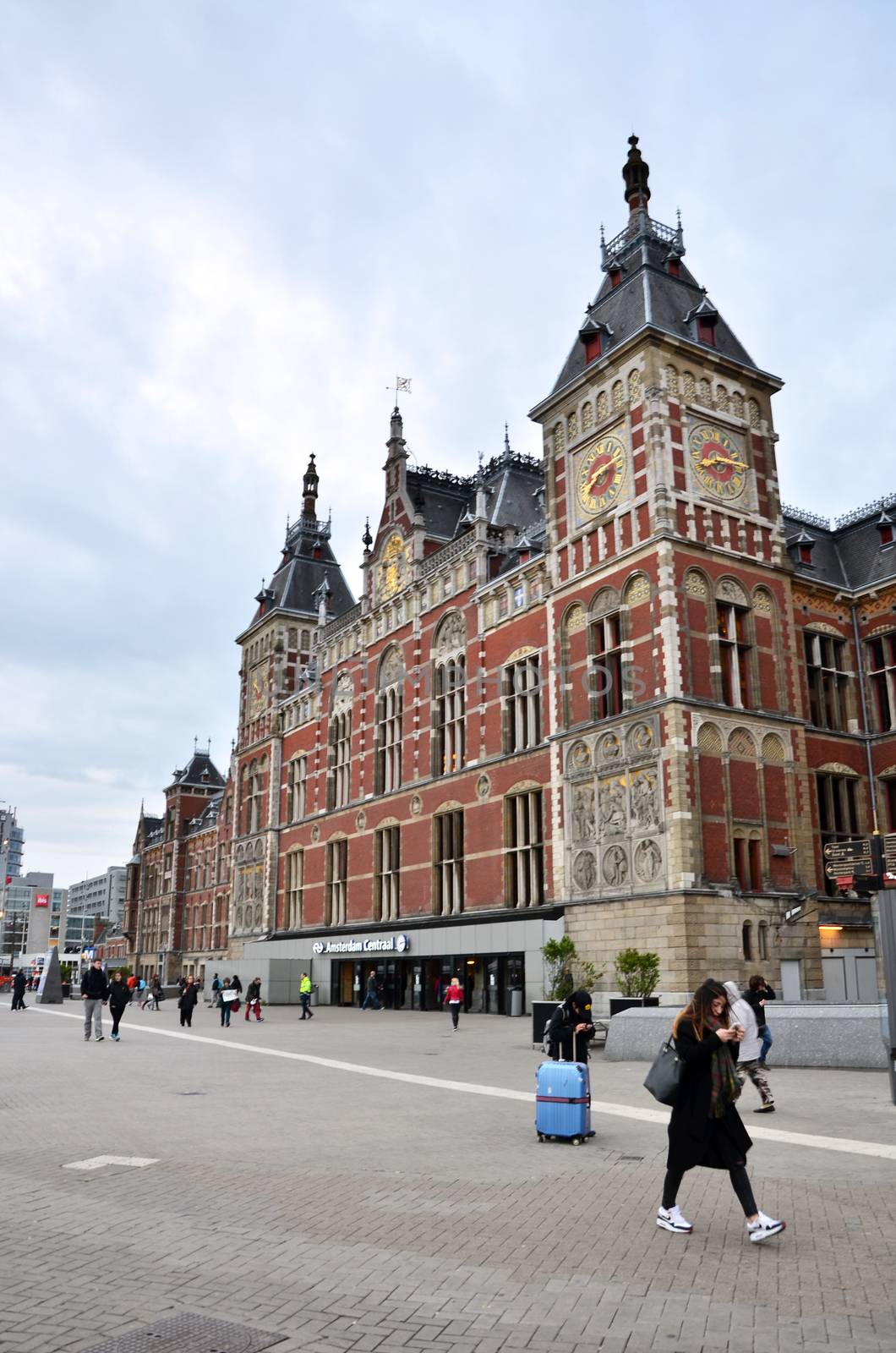 Amsterdam, Netherlands - May 7, 2015: People at Amsterdam Central train station by siraanamwong