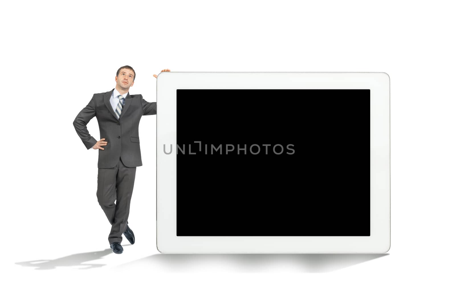 Businessman near big tablet with blank screen by cherezoff