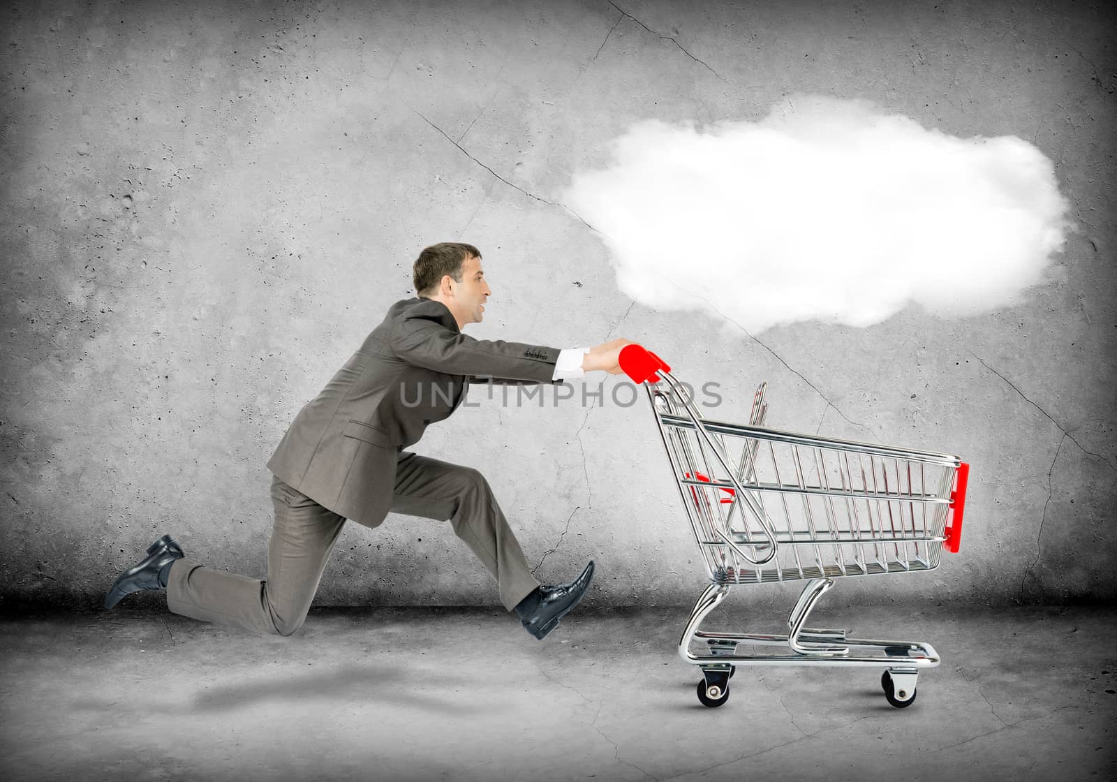 Businessman pushing shopping cart with cloud on grey background