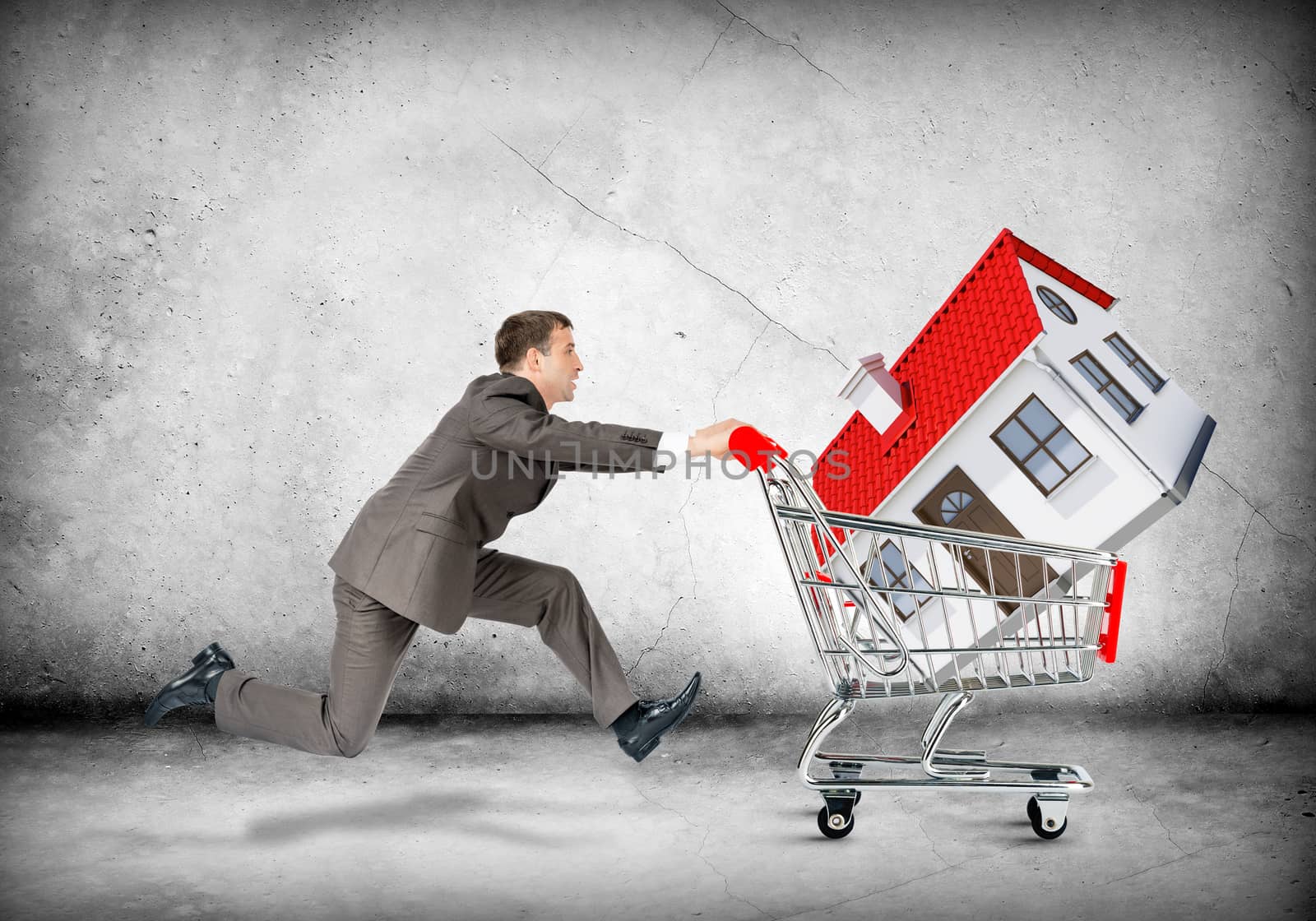 Businessman pushing shopping cart with house on grey background