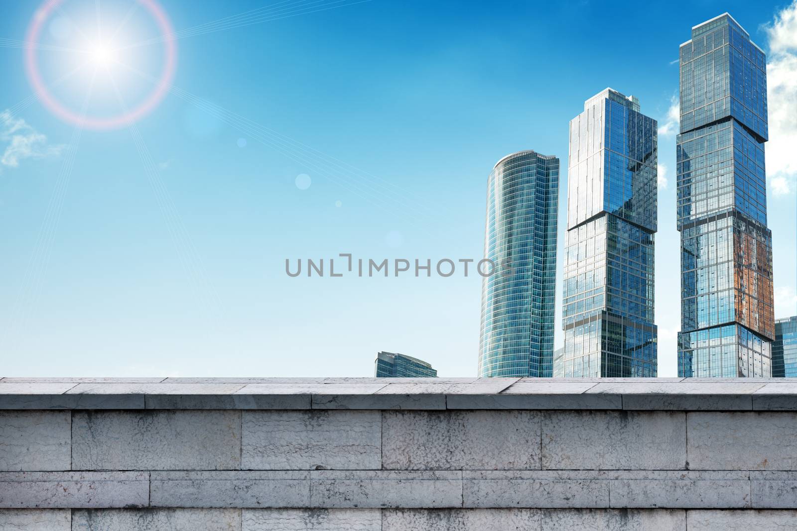 Skyscrapers with grey wall and blue sky, business concept