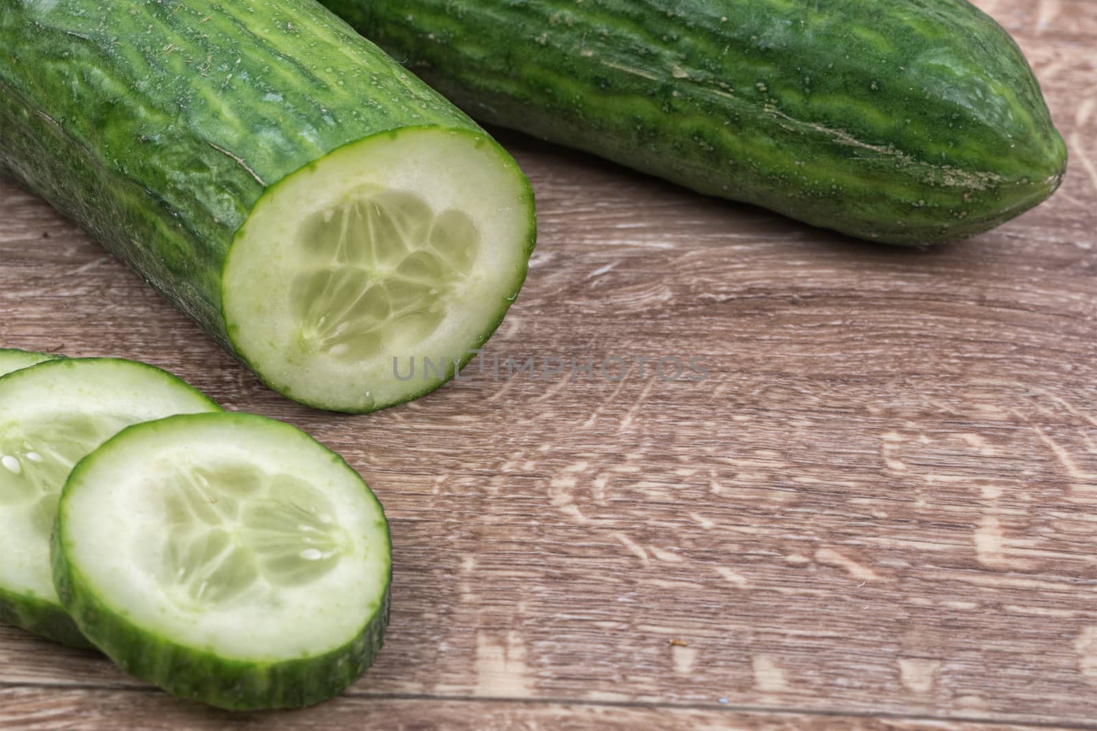 Cucumbers on a brown wooden background
