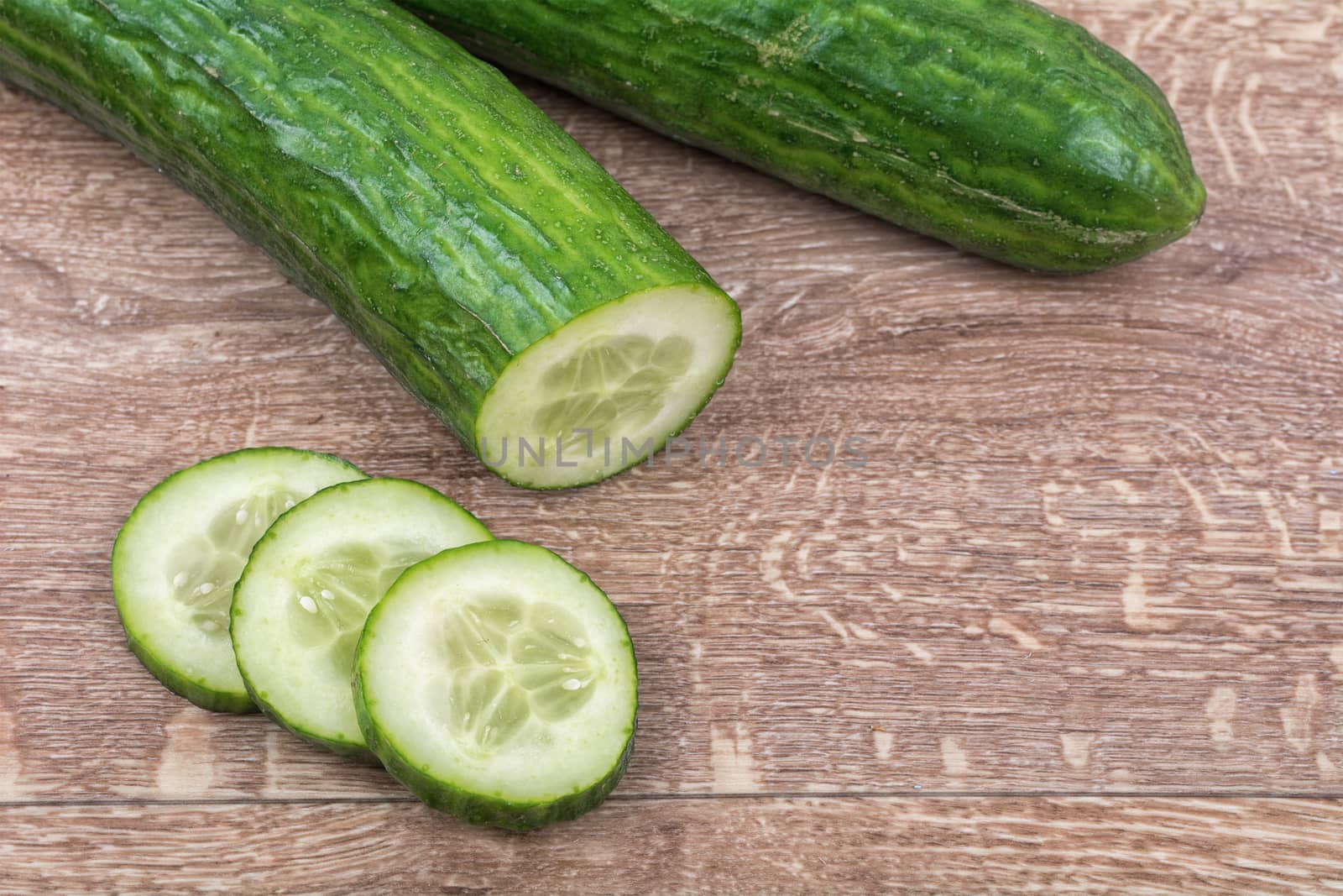 Cucumbers on a brown wooden background