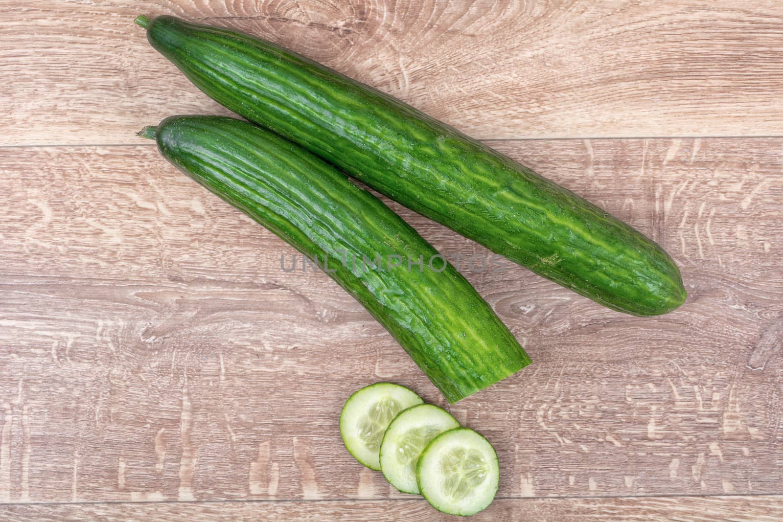 Cucumbers on a brown wooden background