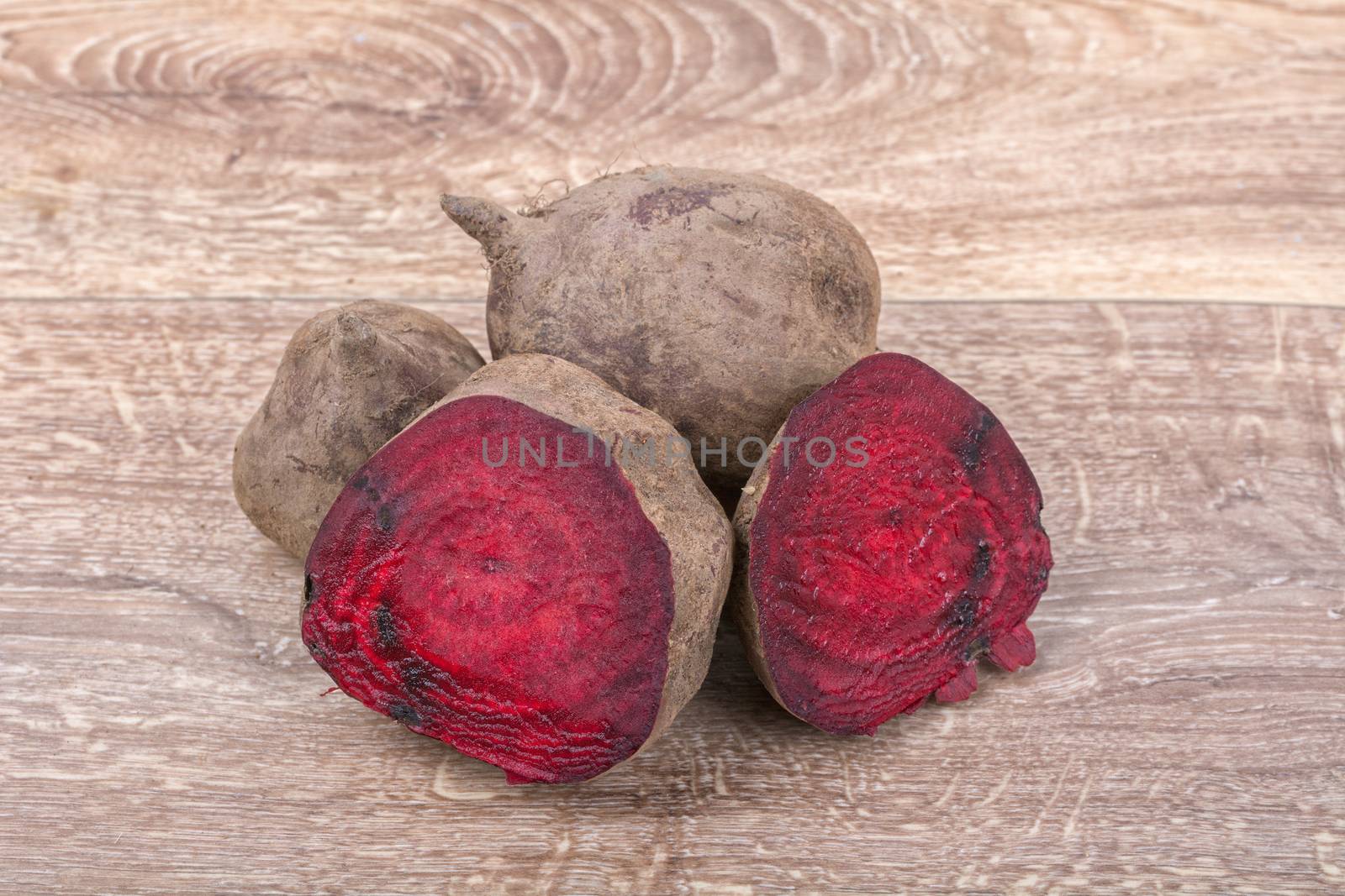 The red beets on a brown wooden background