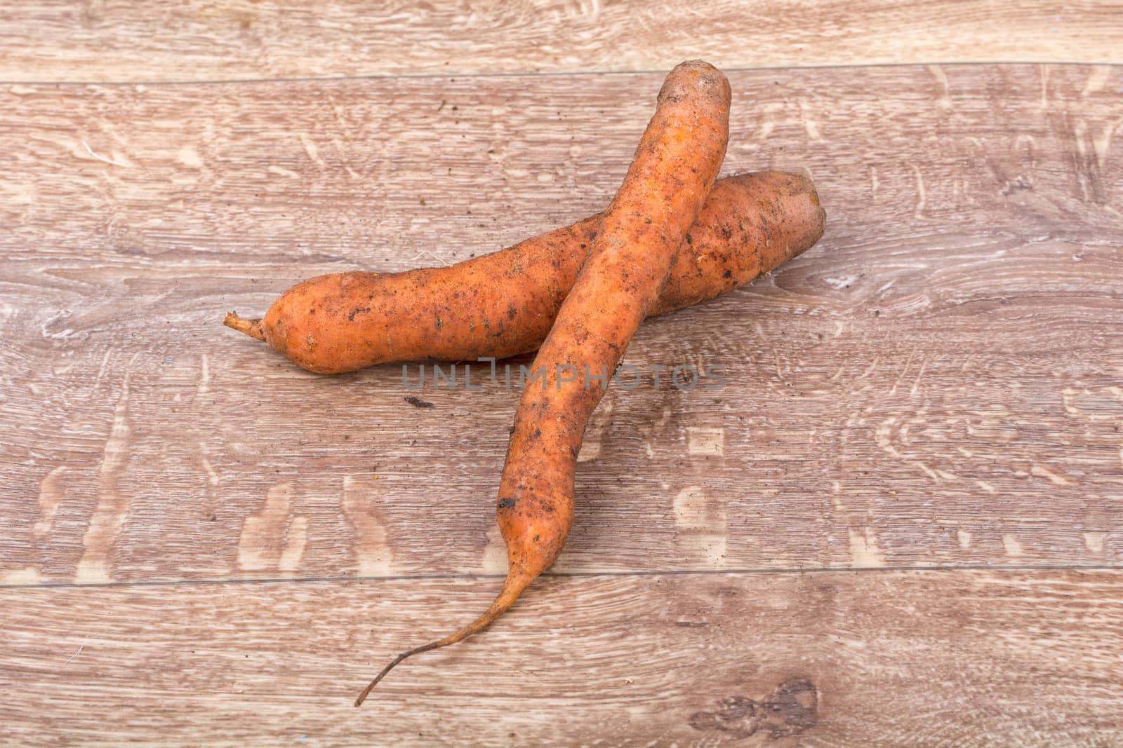 Red carrots on a brown wooden background