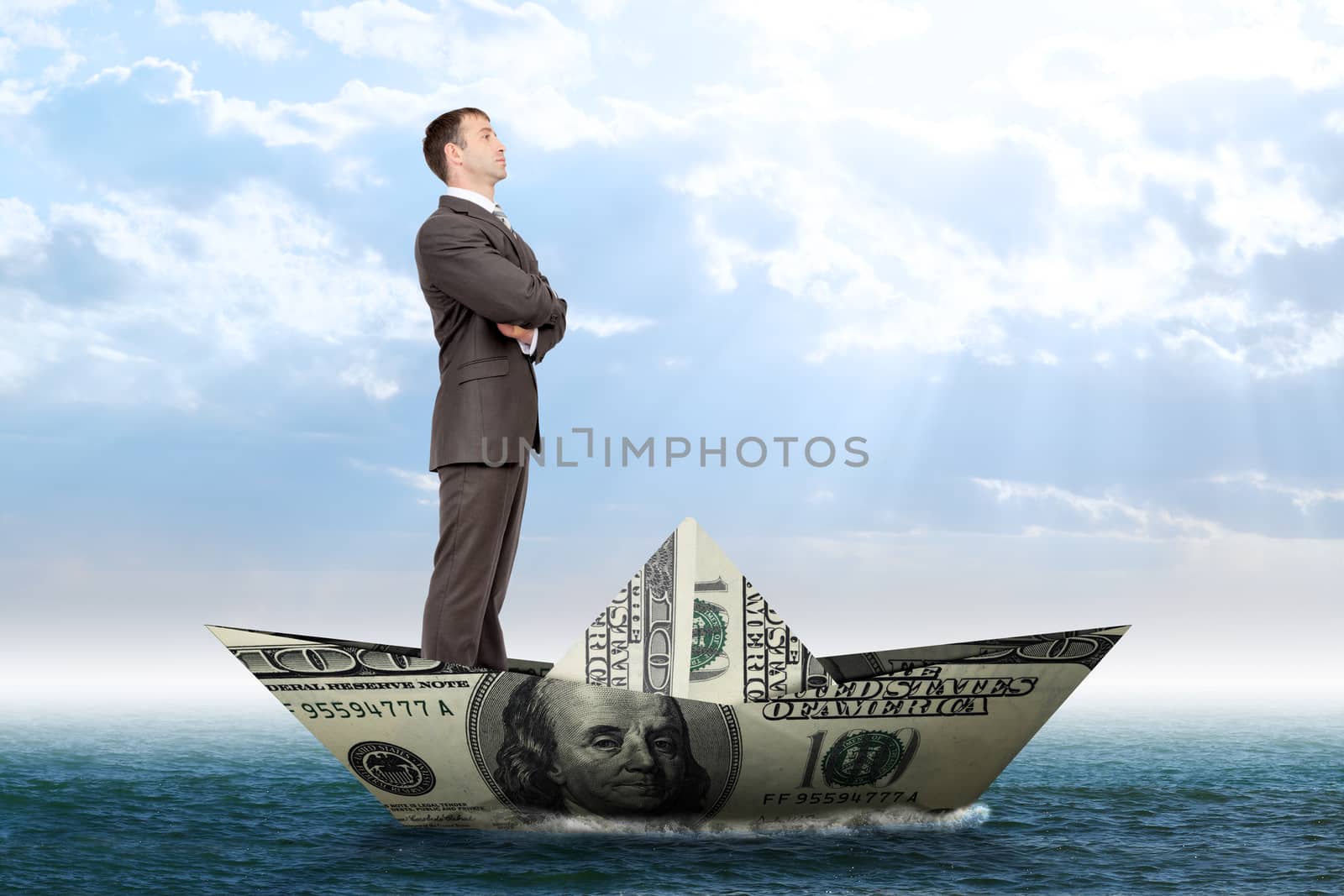 Businessman in dollar boat in blue sea, business concept