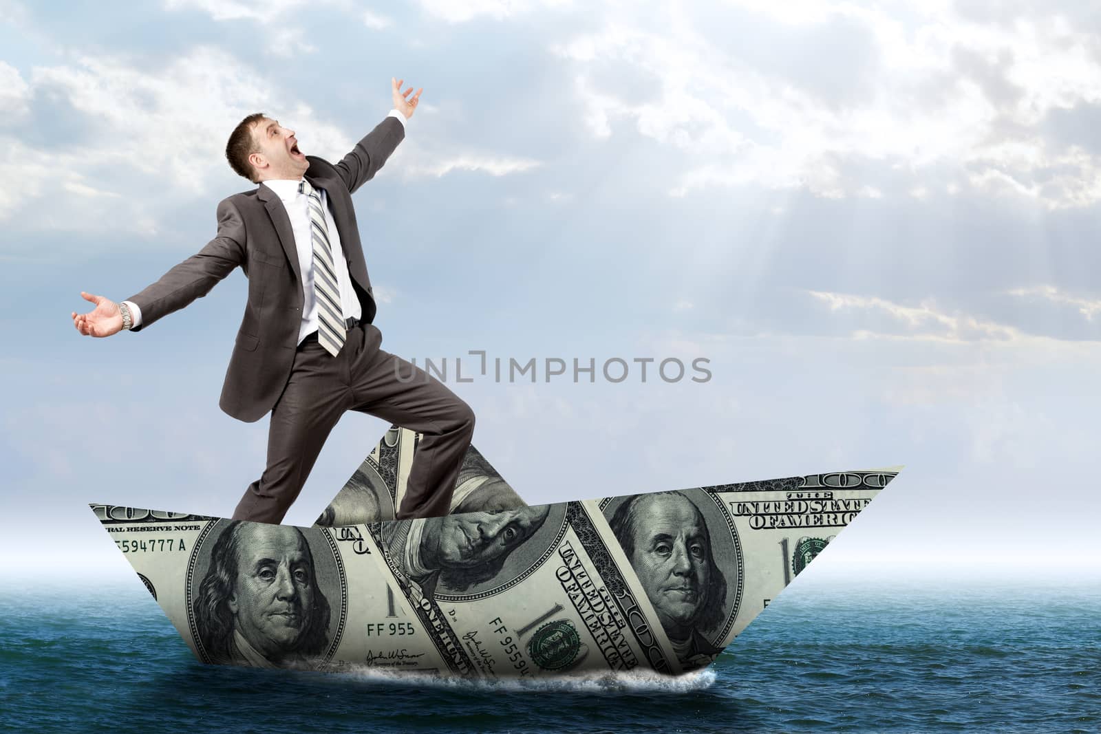 Businessman in dollar boat in blue sea, business concept