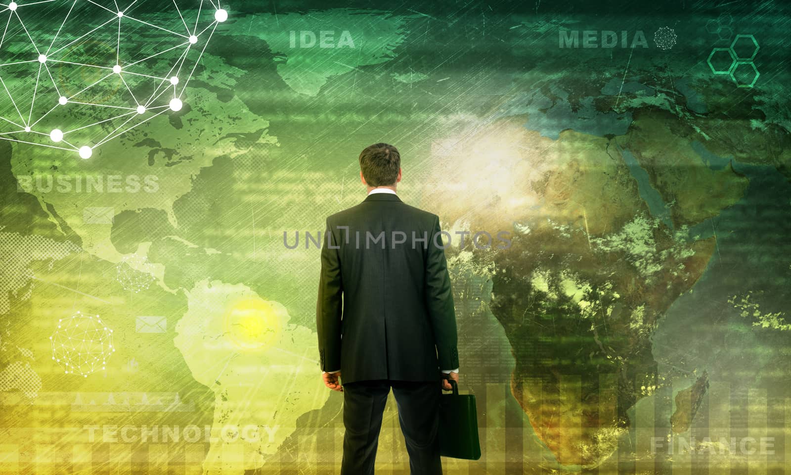 Businessman in front of world map with graphical charts, technology concept