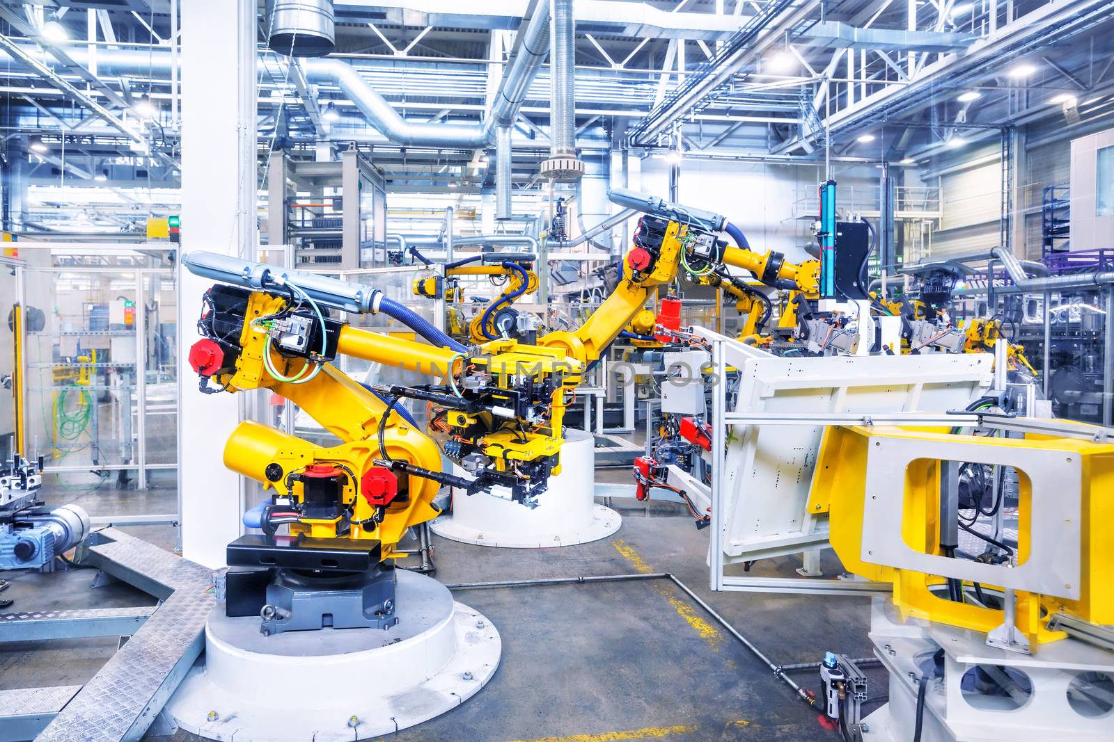 robotic arms in a car plant