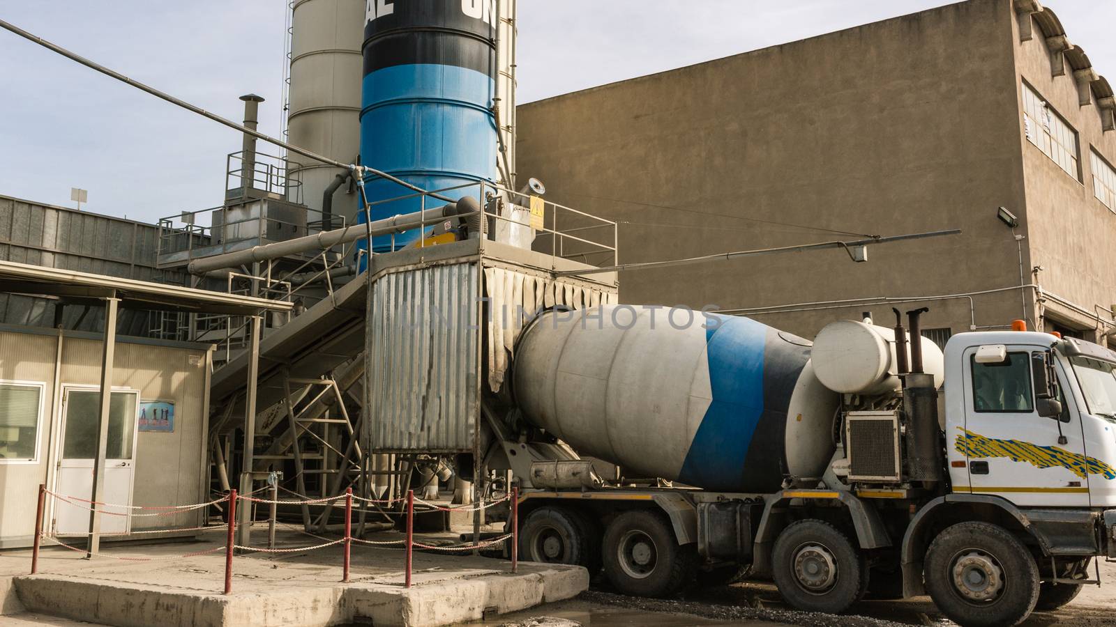 The trucks waiting to load cement from silos