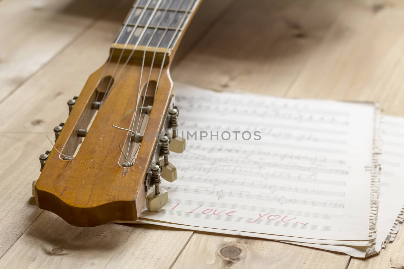 acoustic guitar and musical notes on a table