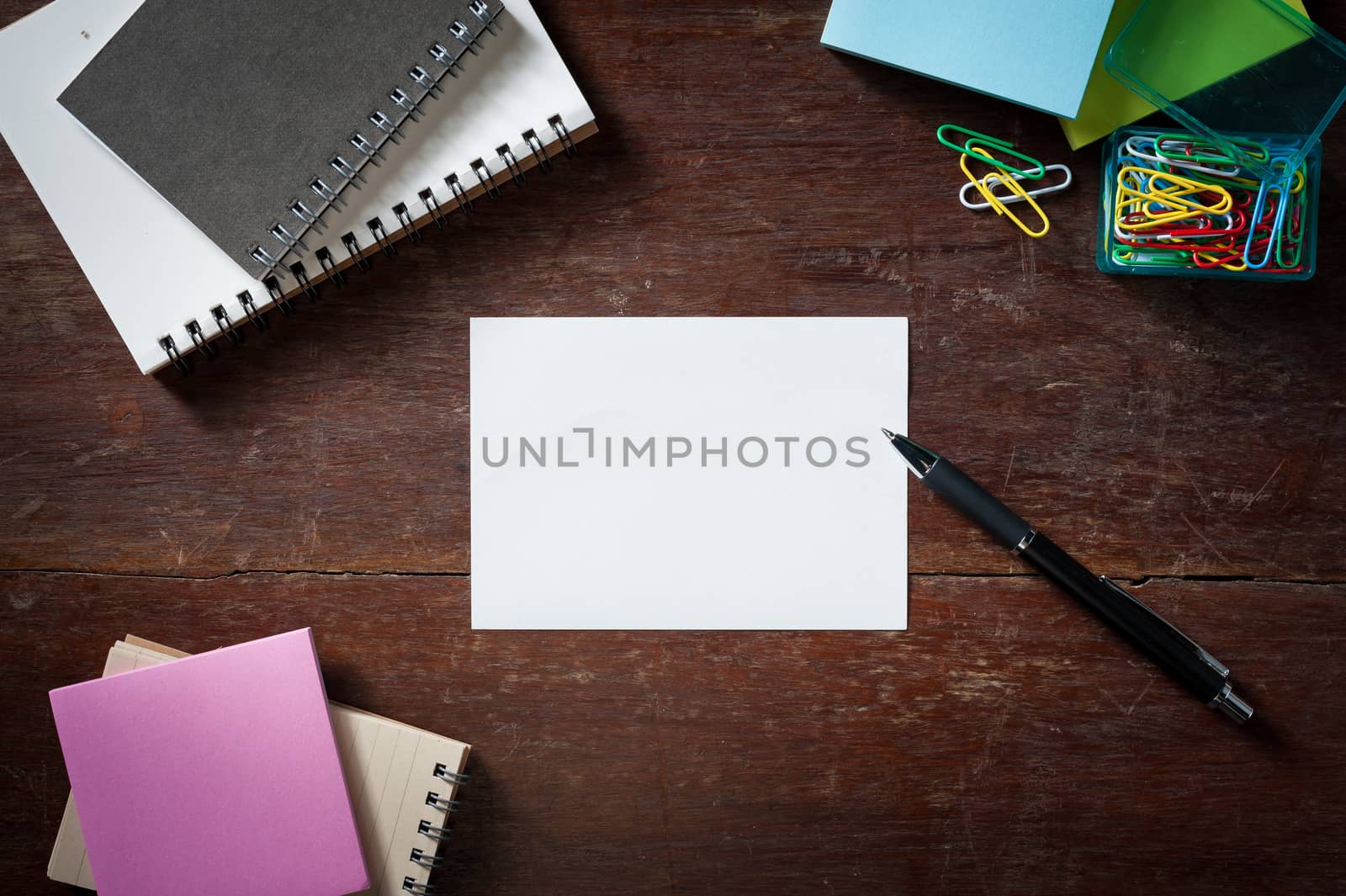 Notepad with blank area for text or message on wood table with low key scene