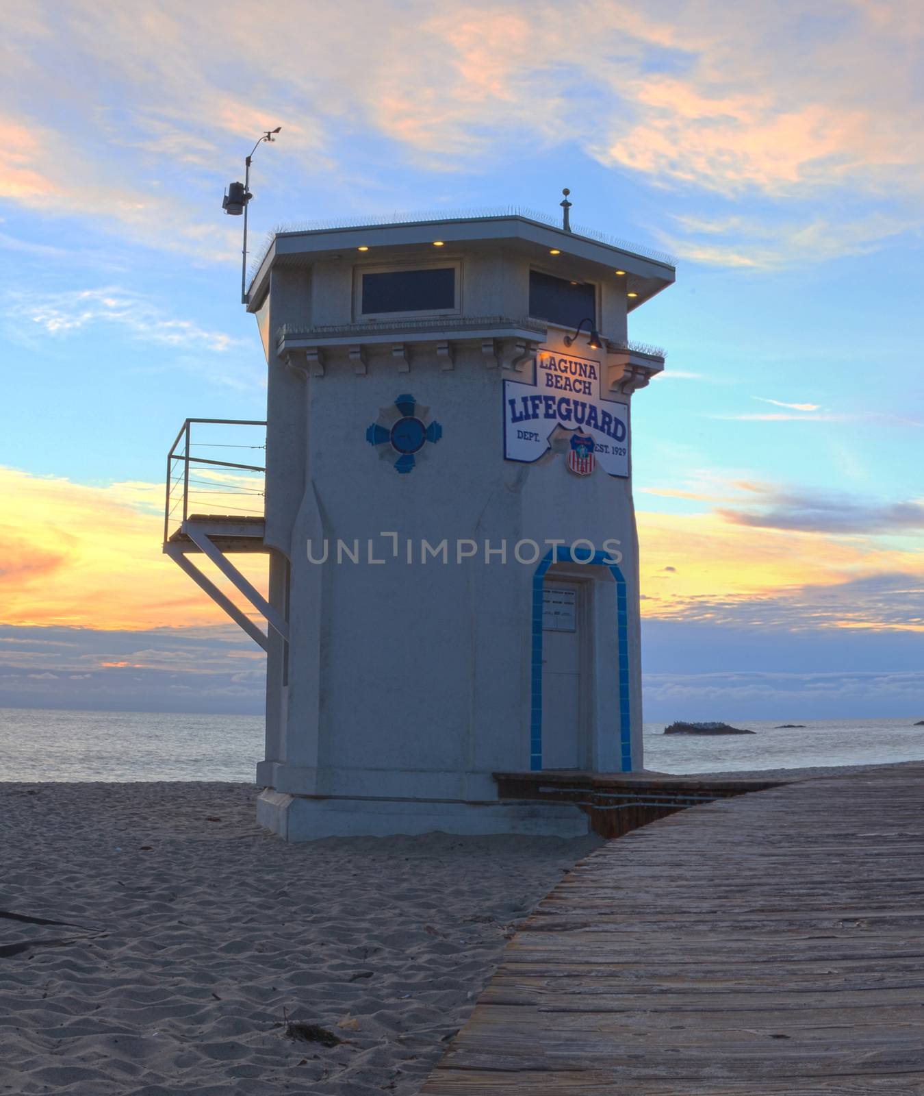Lifeguard on boardwalk at Main beach in Laguna Beach, Southern California at sunset