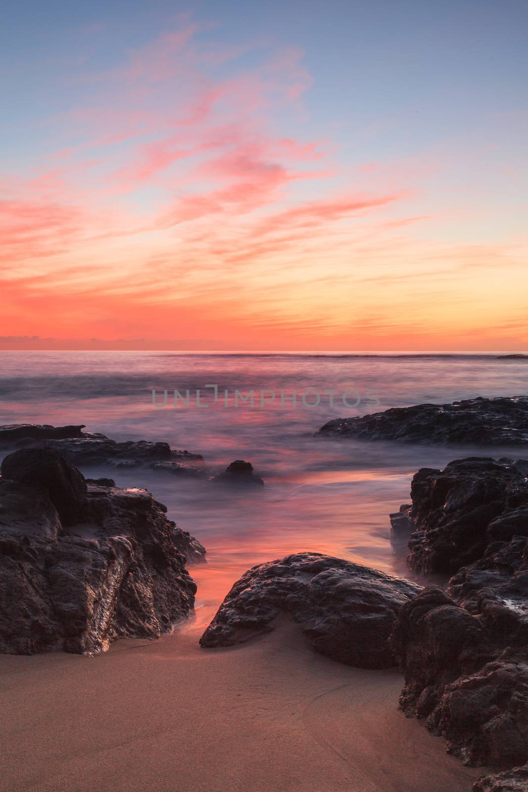 Long exposure of sunset over rocks by steffstarr