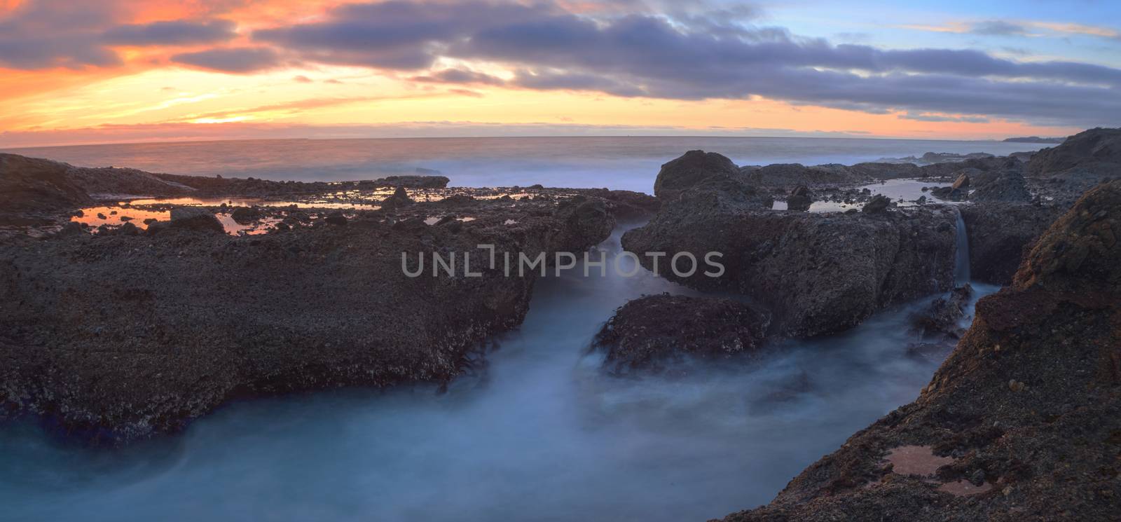 Long exposure of sunset over rocks by steffstarr