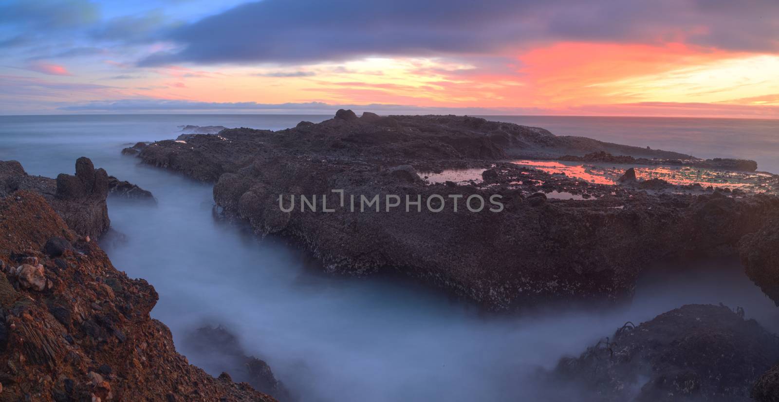 Long exposure of sunset over rocks by steffstarr