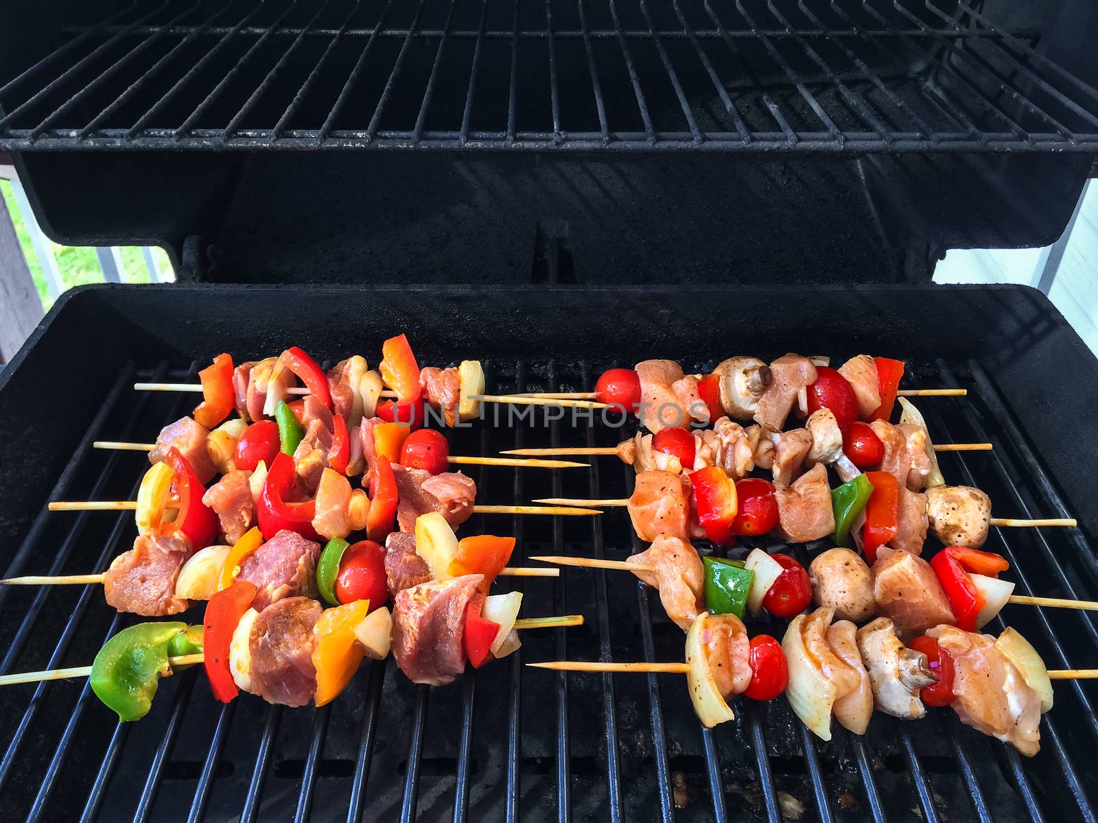 Meat and vegetable skewers on a barbecue grill. Summer bbq.