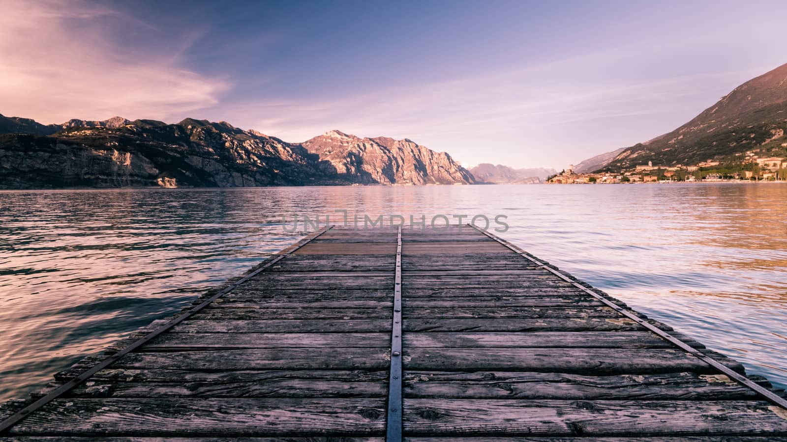 Walkway over the Lake Garda near Malcesine at sunset.