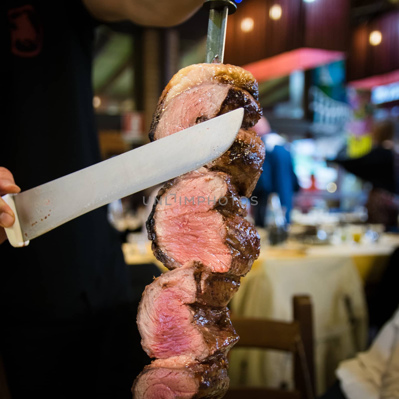 Picanha, traditional Brazilian barbecue sliced directly at the restaurant table.