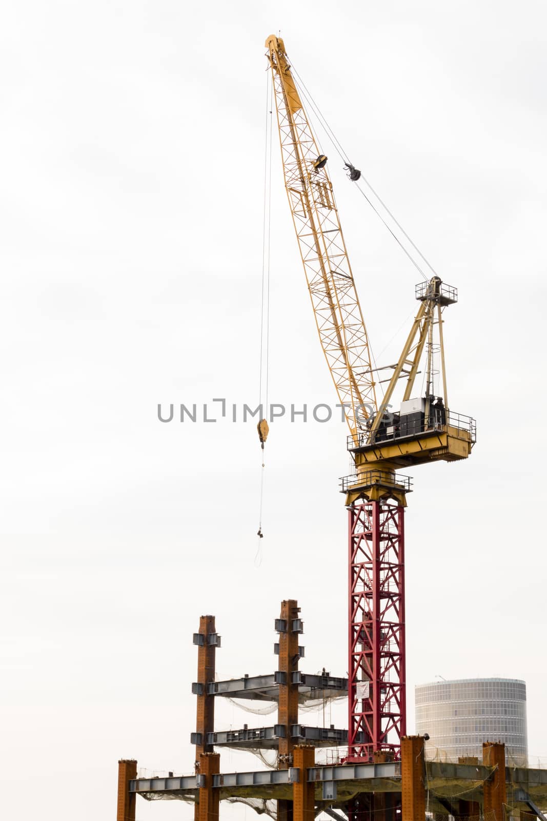 Big building being constructed with crane on top
