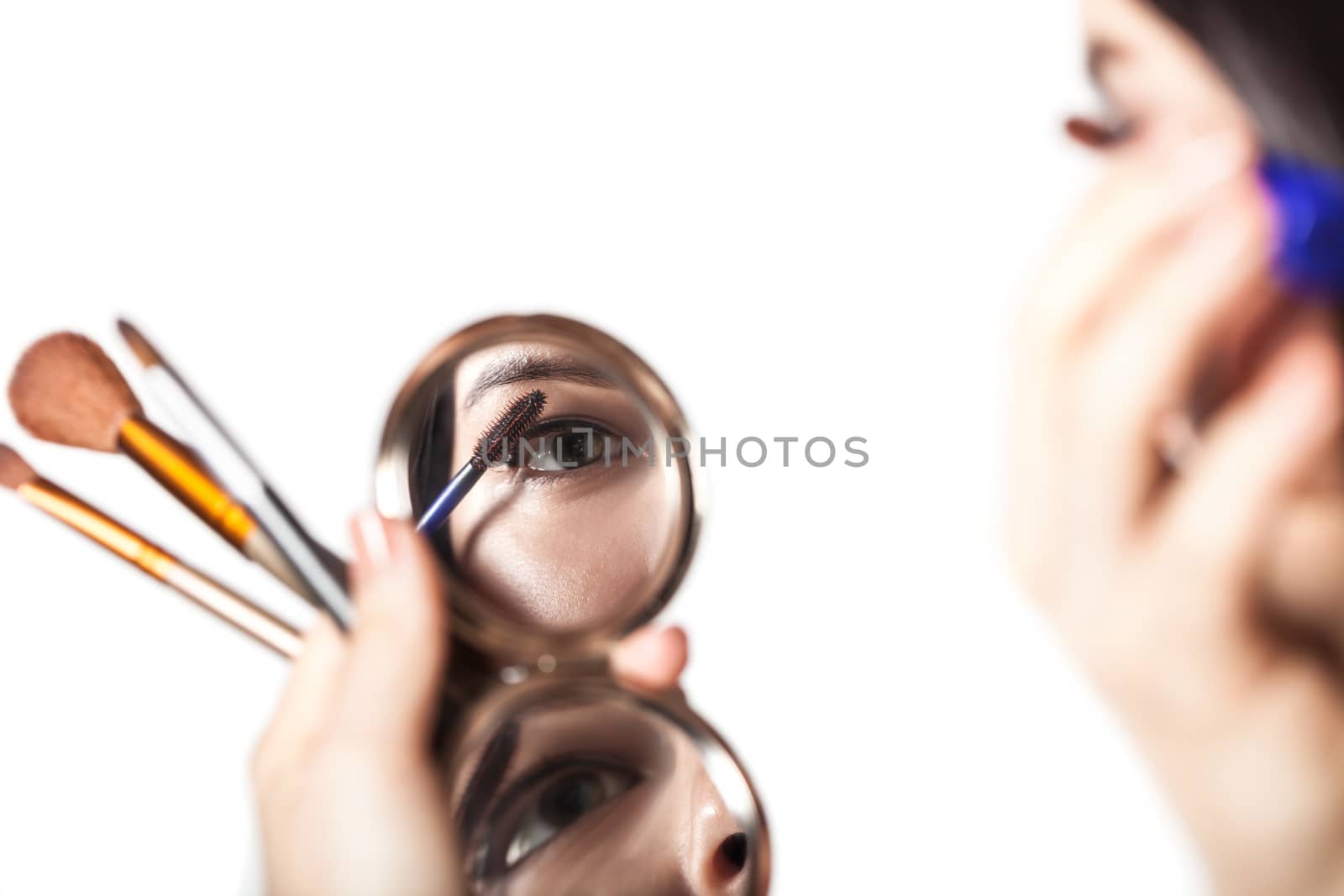 the girl does make-up on a white background