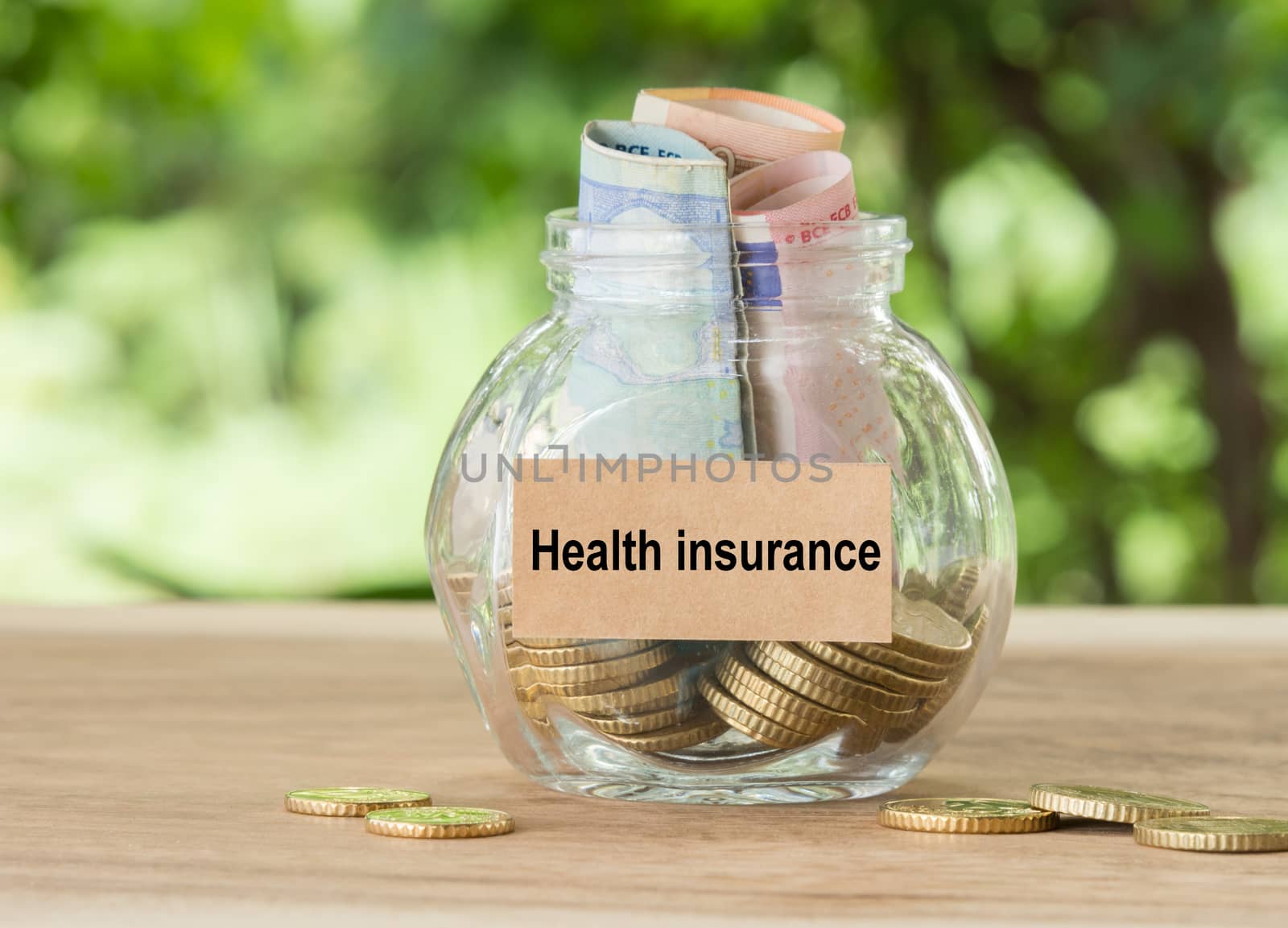 money in jar with health insurance label - financial concept