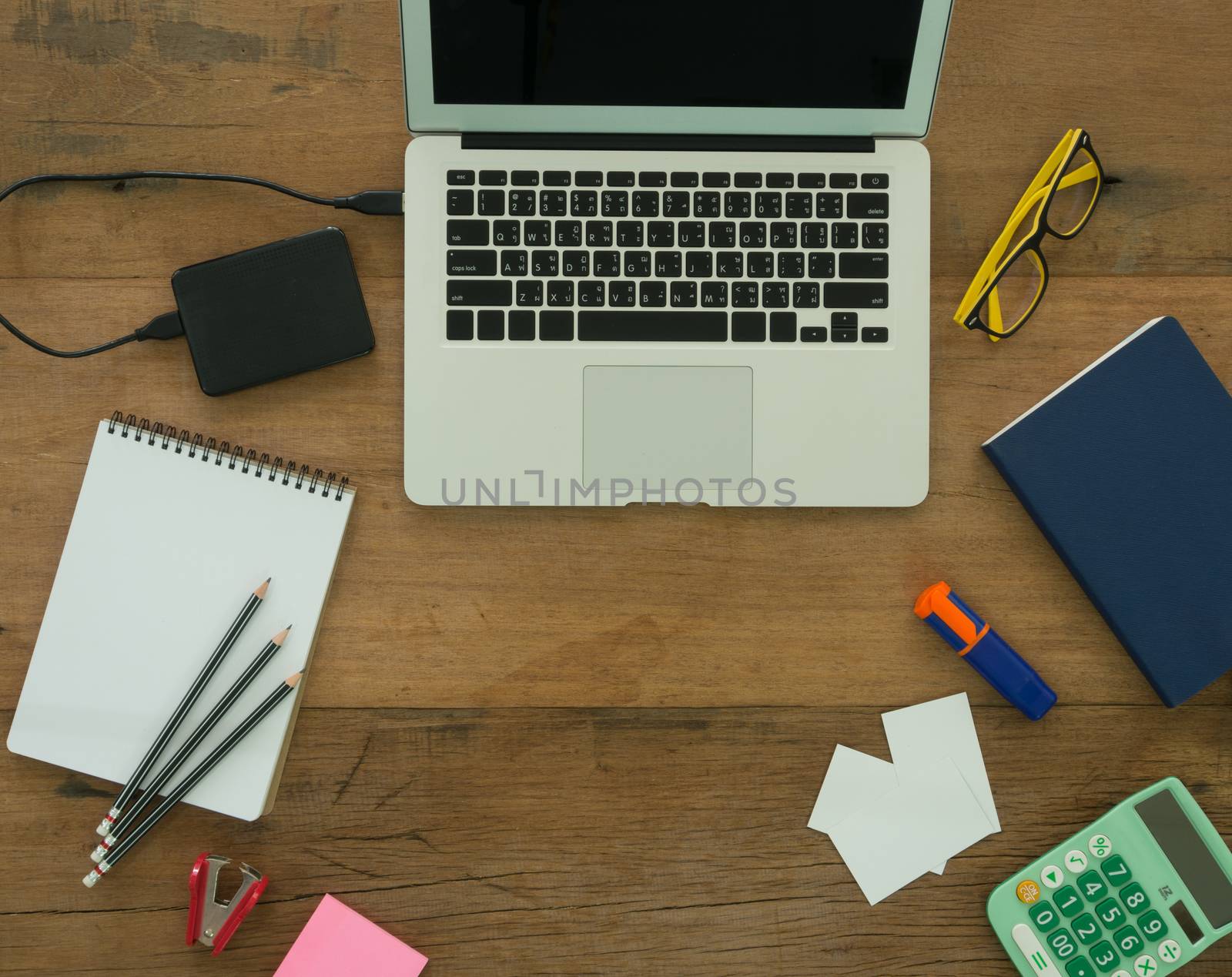 Equipment designer with stationary ,laptop computer on the desk. view top.