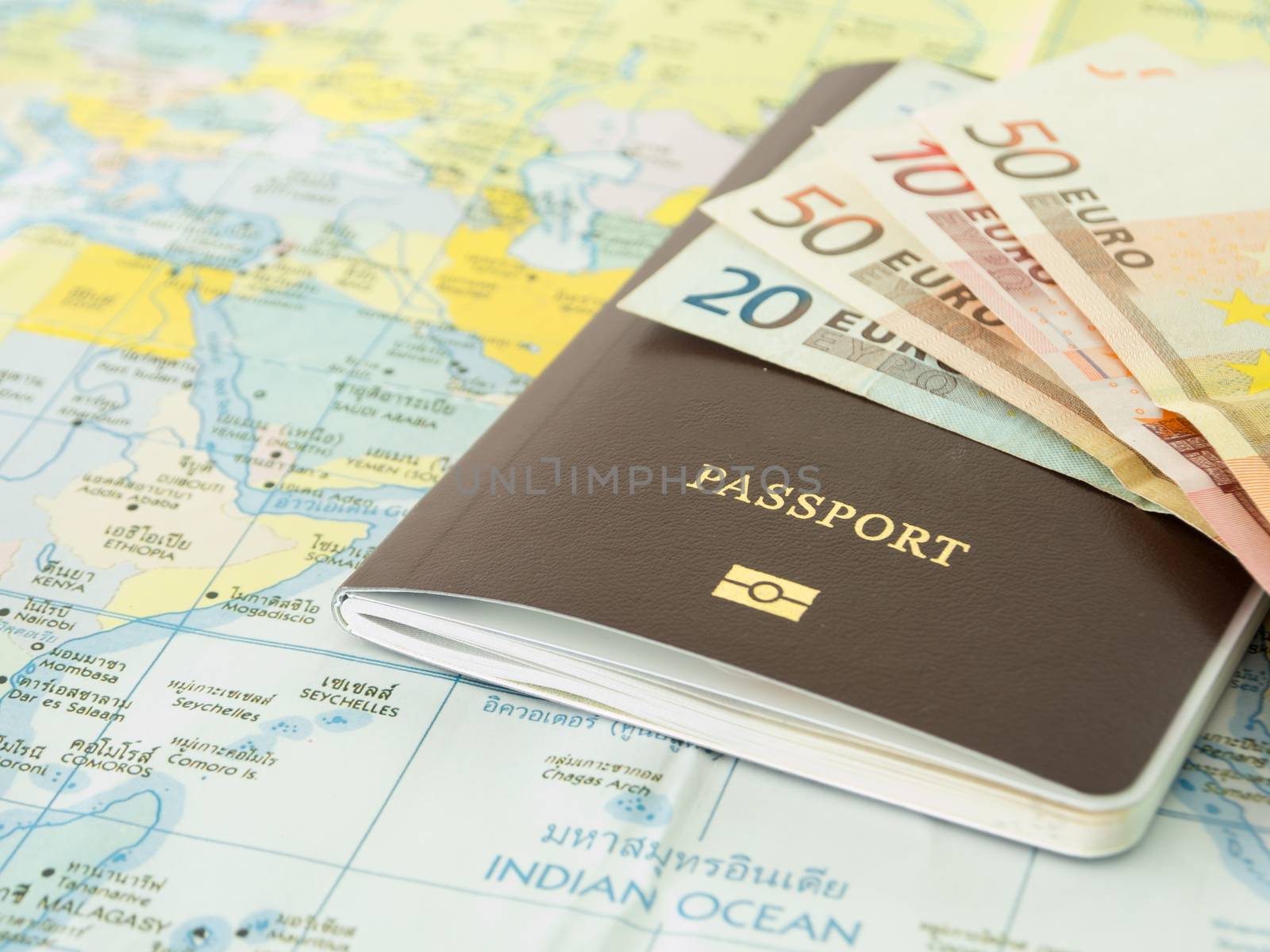 closeup passport on world map with banknote