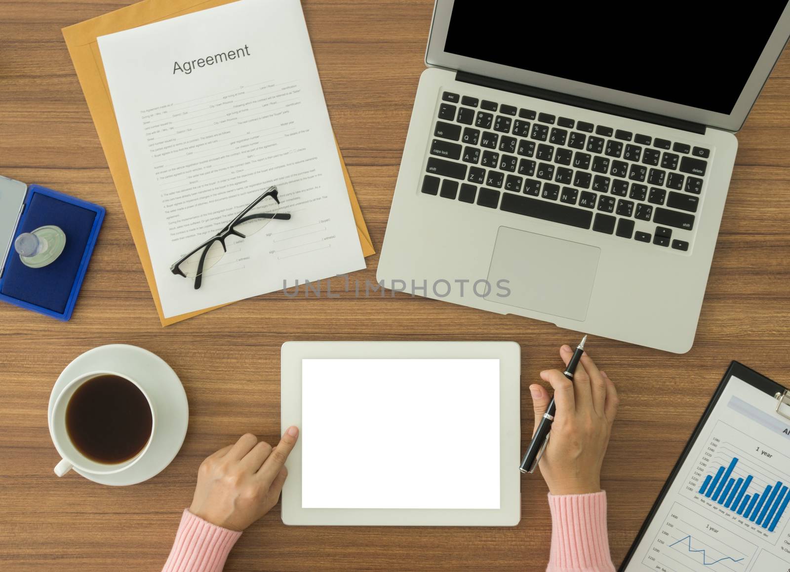 woman working at office desk and using tablet computer.  free space for text.