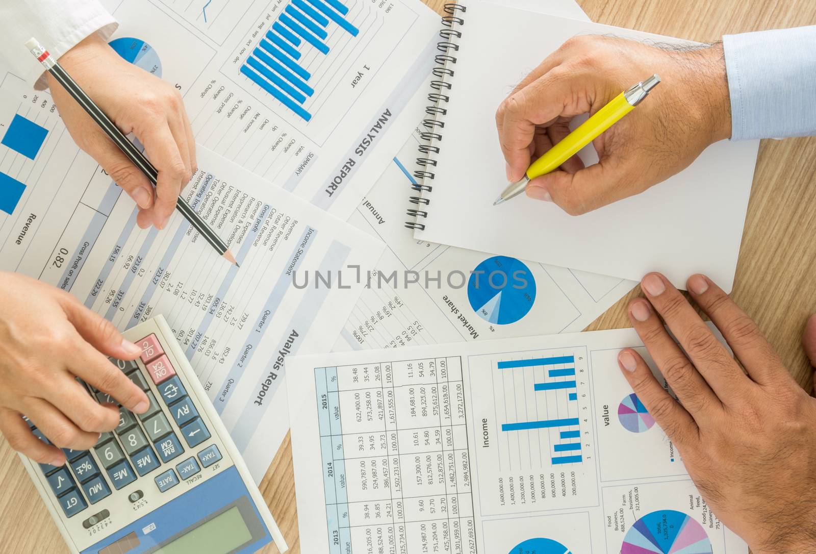 marketer worker analyzing statistical data on desk in office. top view