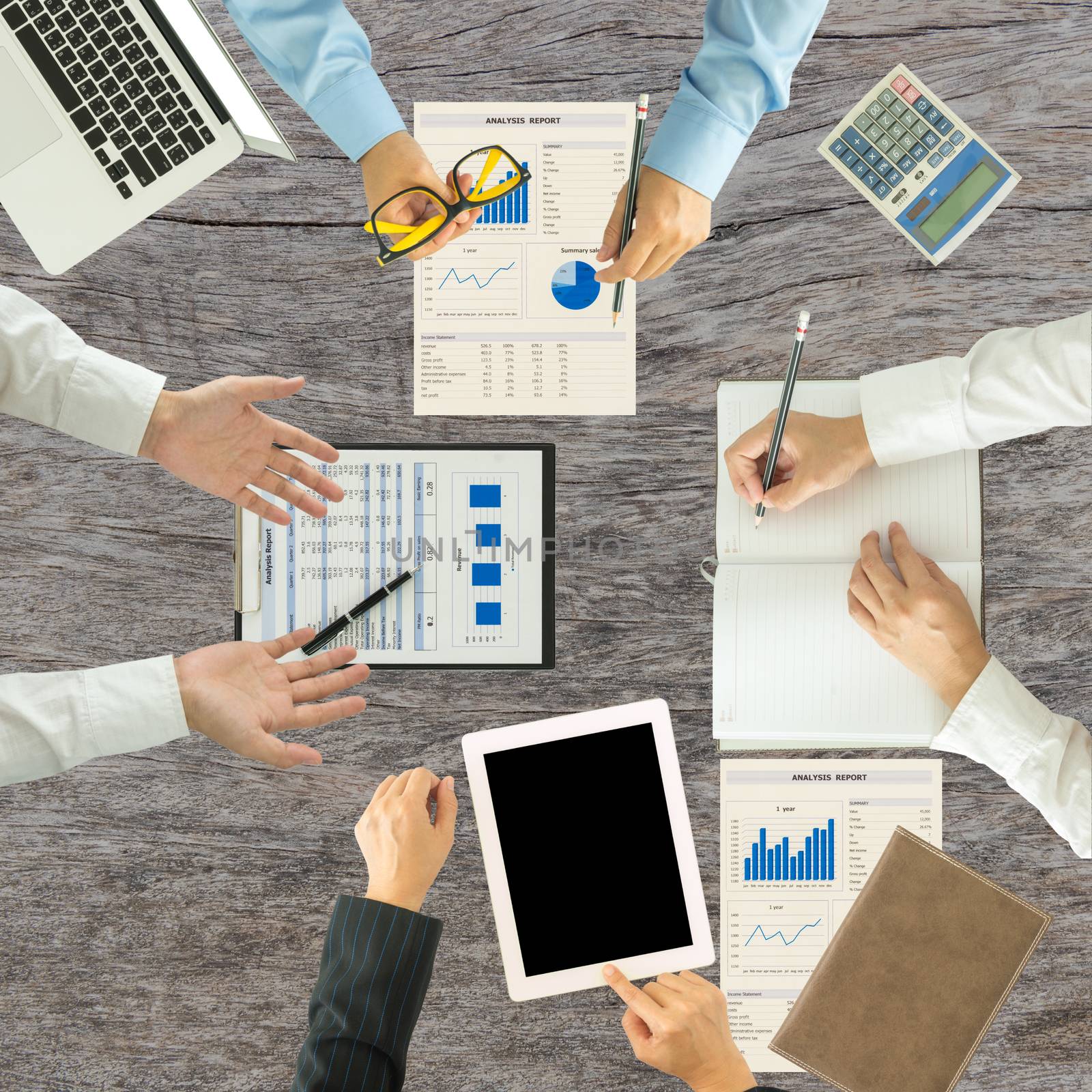 Top view of group of business people working on an office desk.