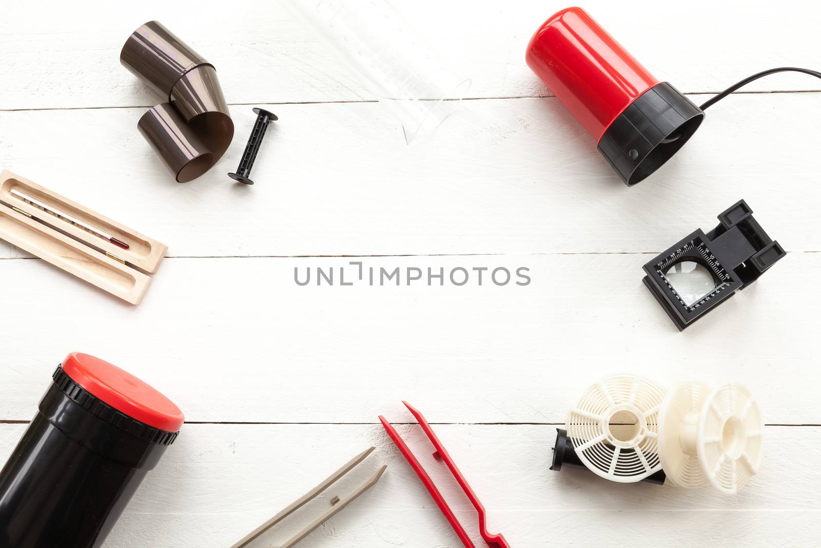 Developing can, thermomether, reels and red light seen from above by andongob