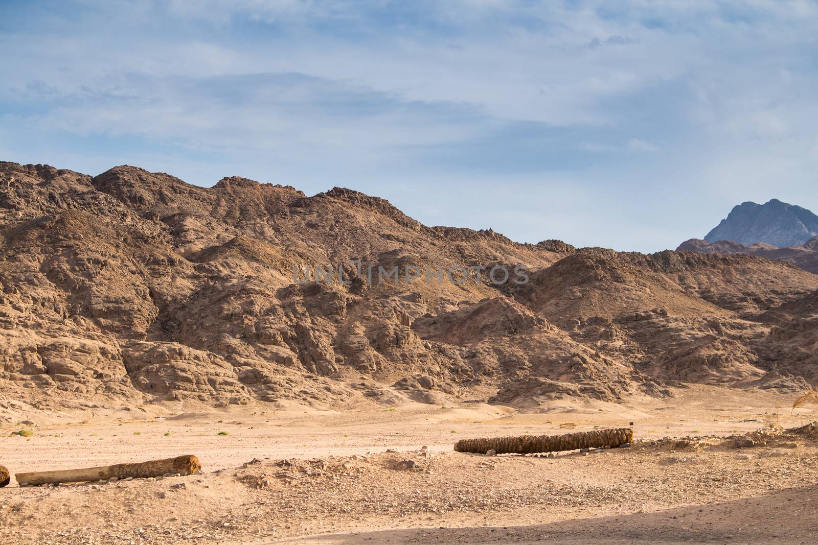 Rounded edges of the mountains in egyptian desert. Cloudy sky.