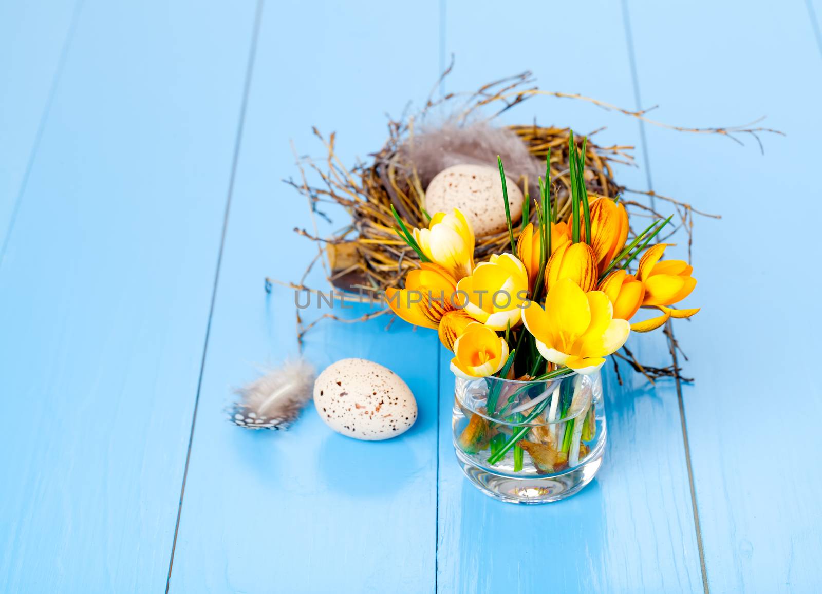table decoration with easter eggs, on blue wooden background
