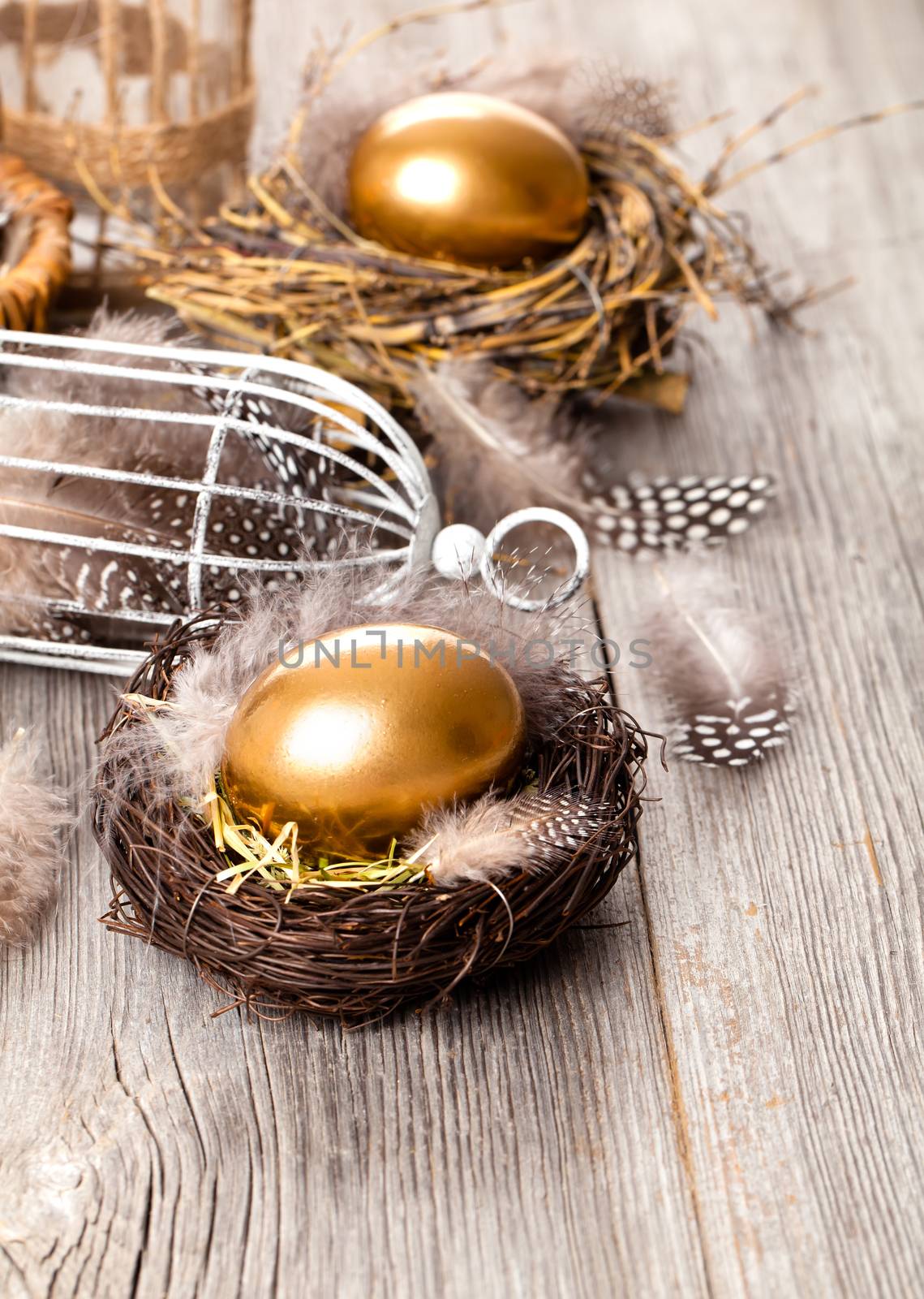 golden egg of chickens in nest, on wooden background by motorolka