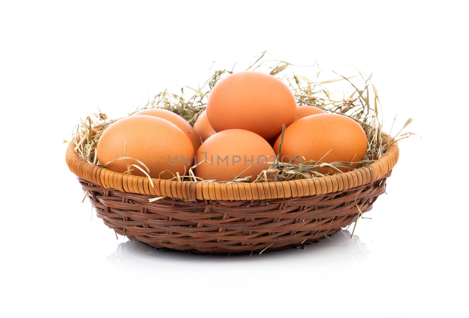 Eggs in basket isolated on white background by motorolka