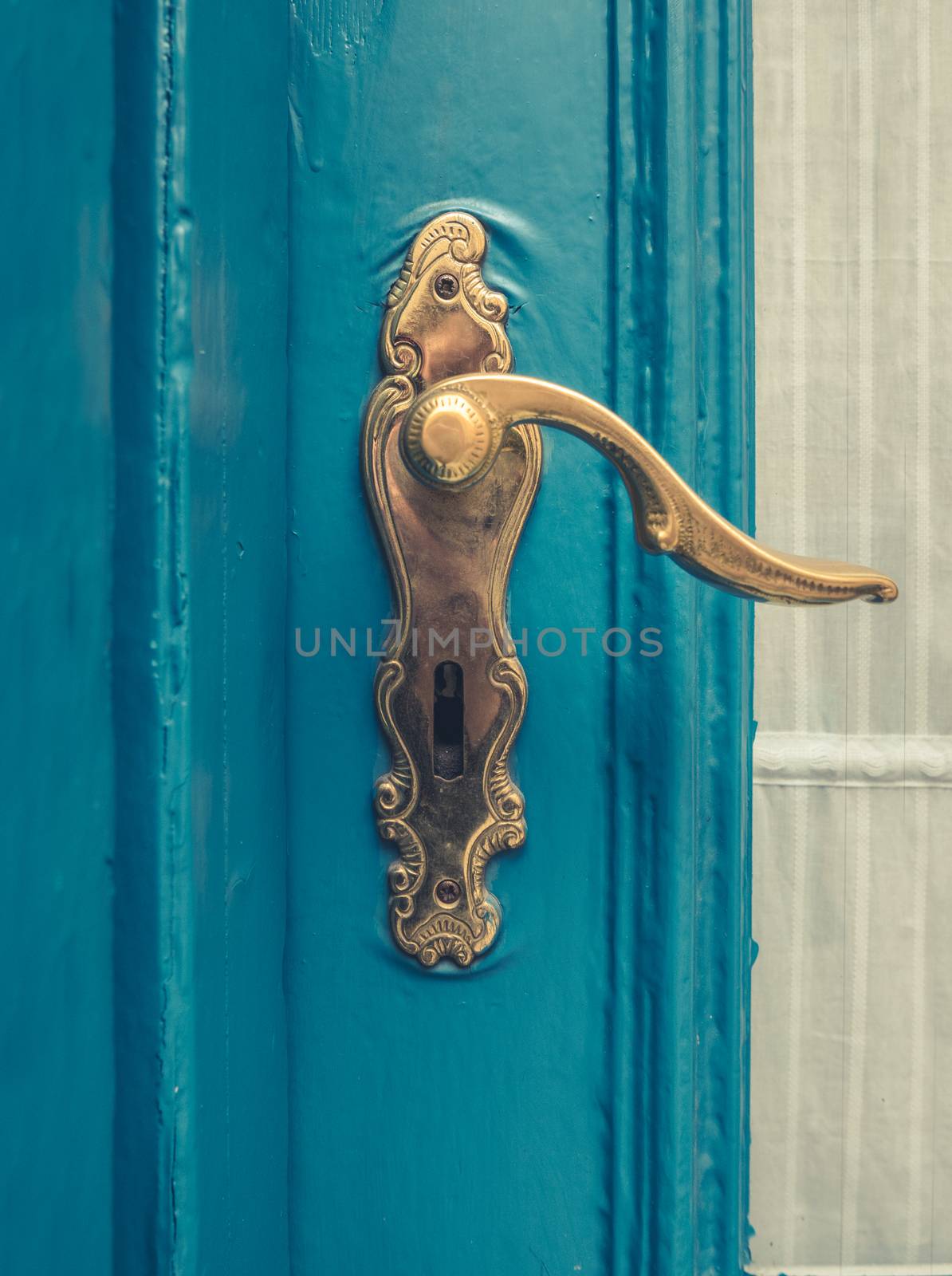 Architectural Detail Of A Vintage Brass Door Handle On A Blue Painted Door