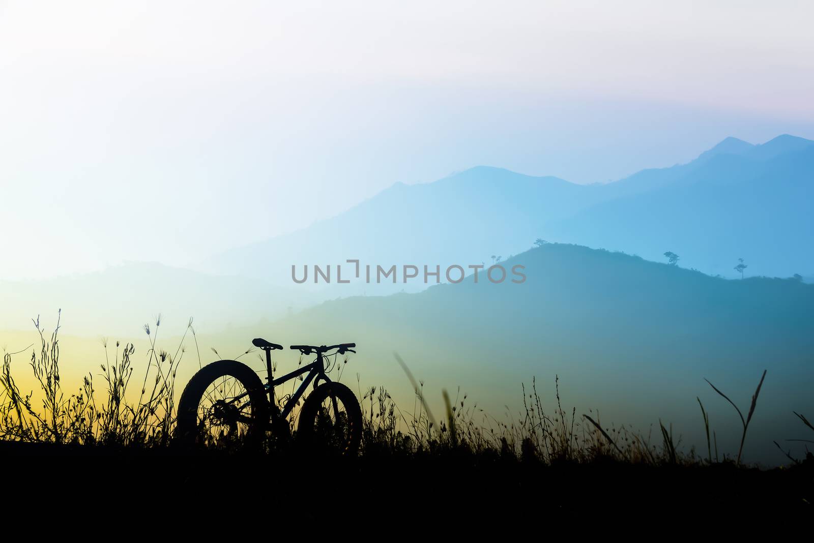 beautiful sunset sky and mountain bike silhouette , silhouette fat bike