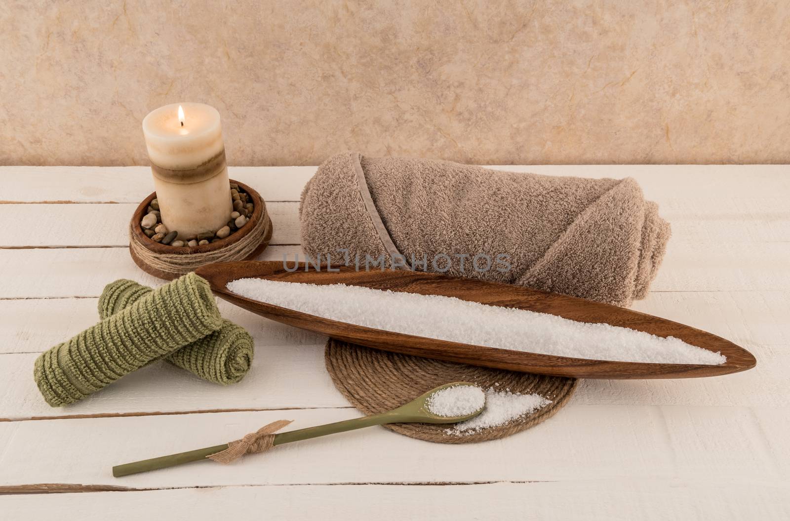 Mineral Bath Salts with Spa Towel and Candle on rustic white wood planks