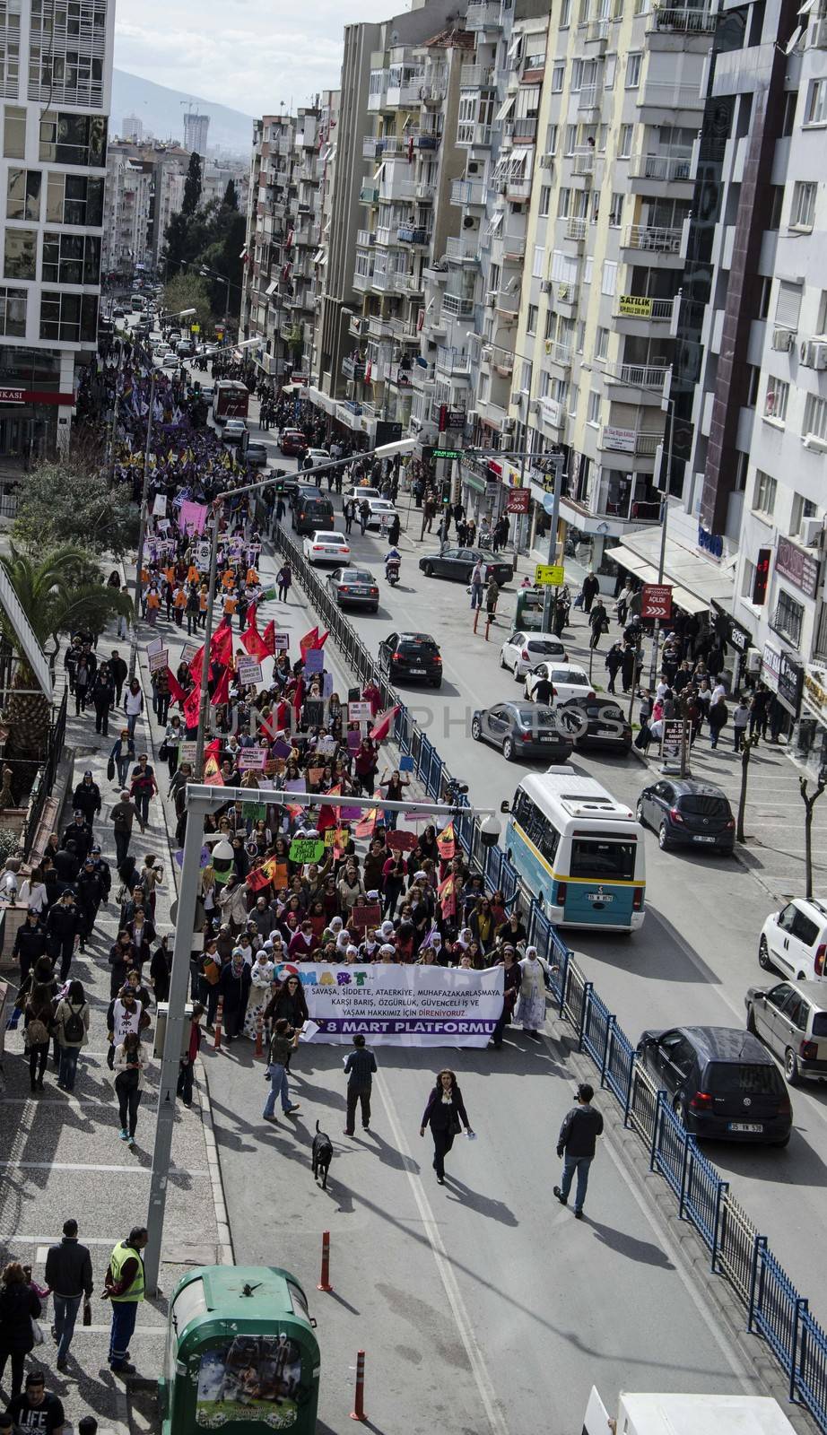 TURKEY, Izmir: Protesters march behind a banner during a demonstration held in Izmir, Turkey on March 6, 2016 prior to International Women's Day (March 8).