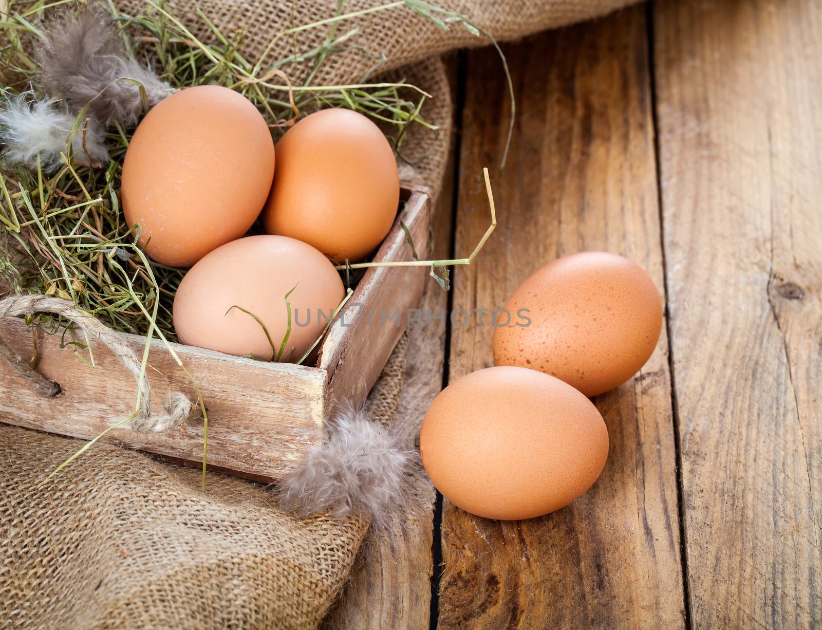 Eggs on wooden background by motorolka