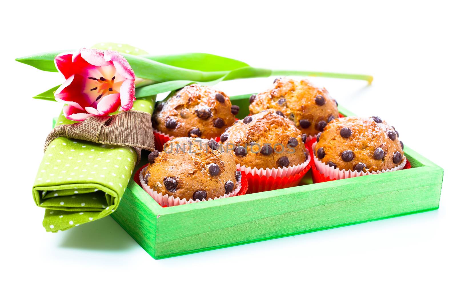 Muffins with tulips isolated on white background