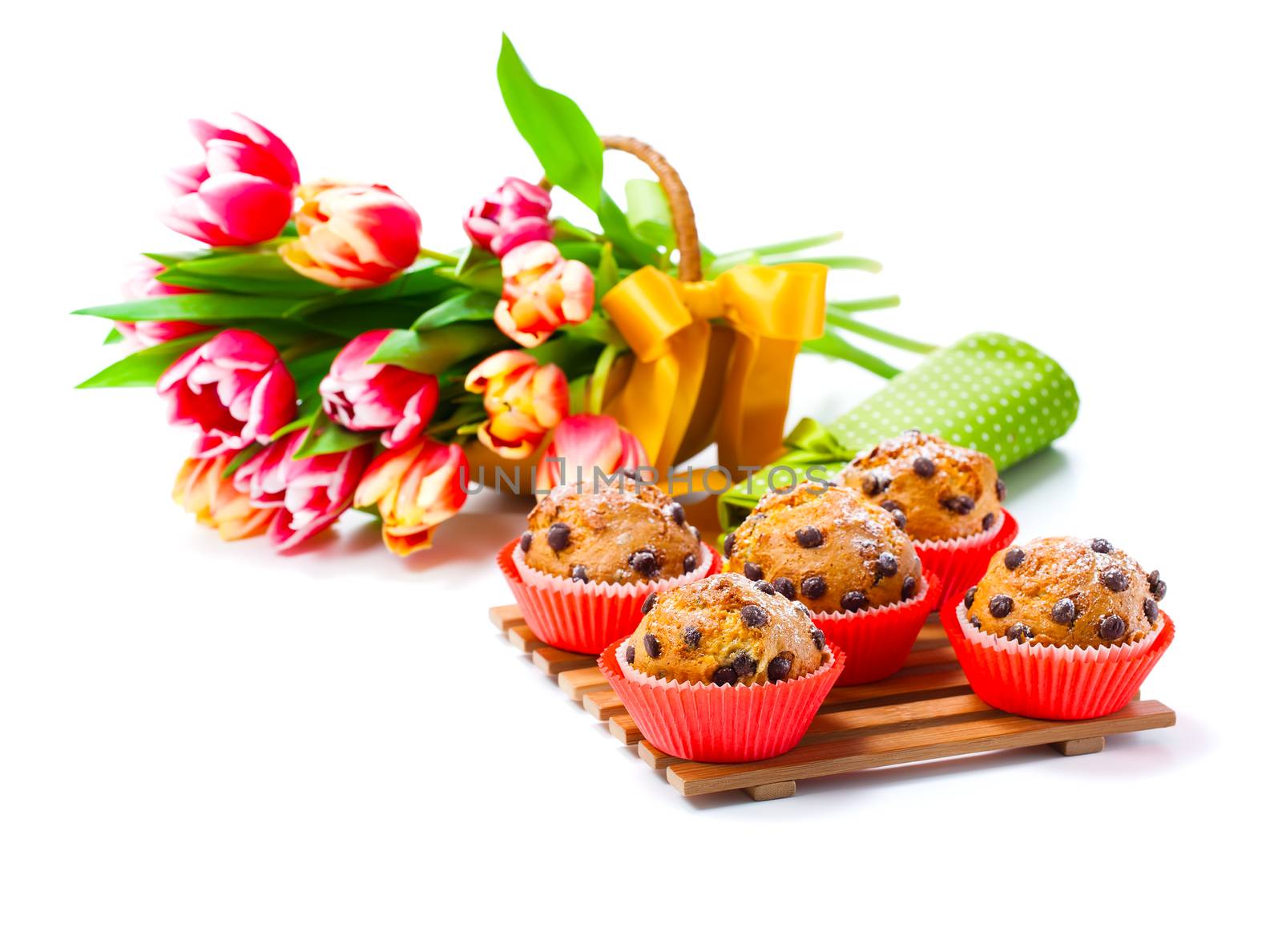 Muffins with tulips isolated on white background by motorolka