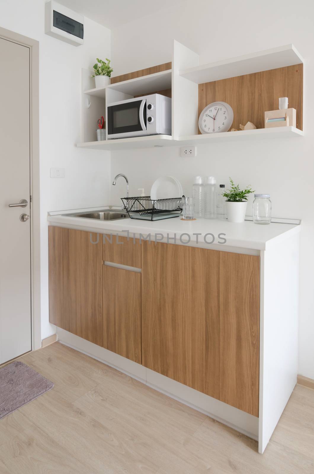 Modern pantry with utensil and sink in apartment