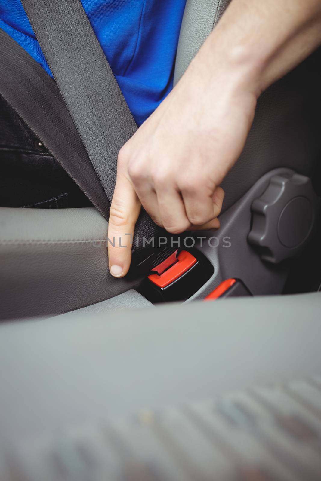 Man buckling his seatbelt by Wavebreakmedia